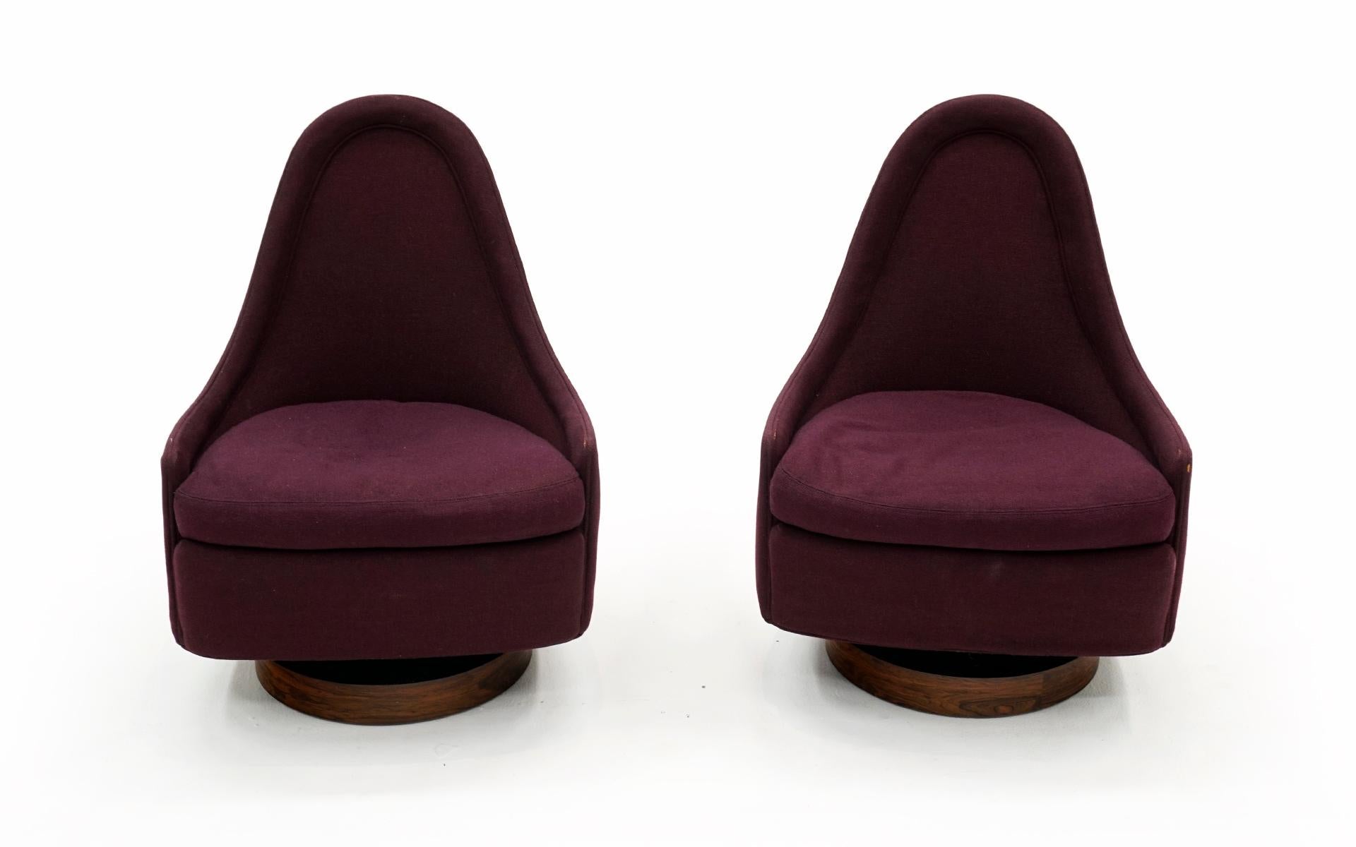 Pair of small / petite rocking swivel chairs designed by Milo Baughman for Thayer Coggin. Rare and highly desirable design made even more rare with Brazilian rosewood bases. Both retain the original Thayer Coggin labels. Chairs are in excellent