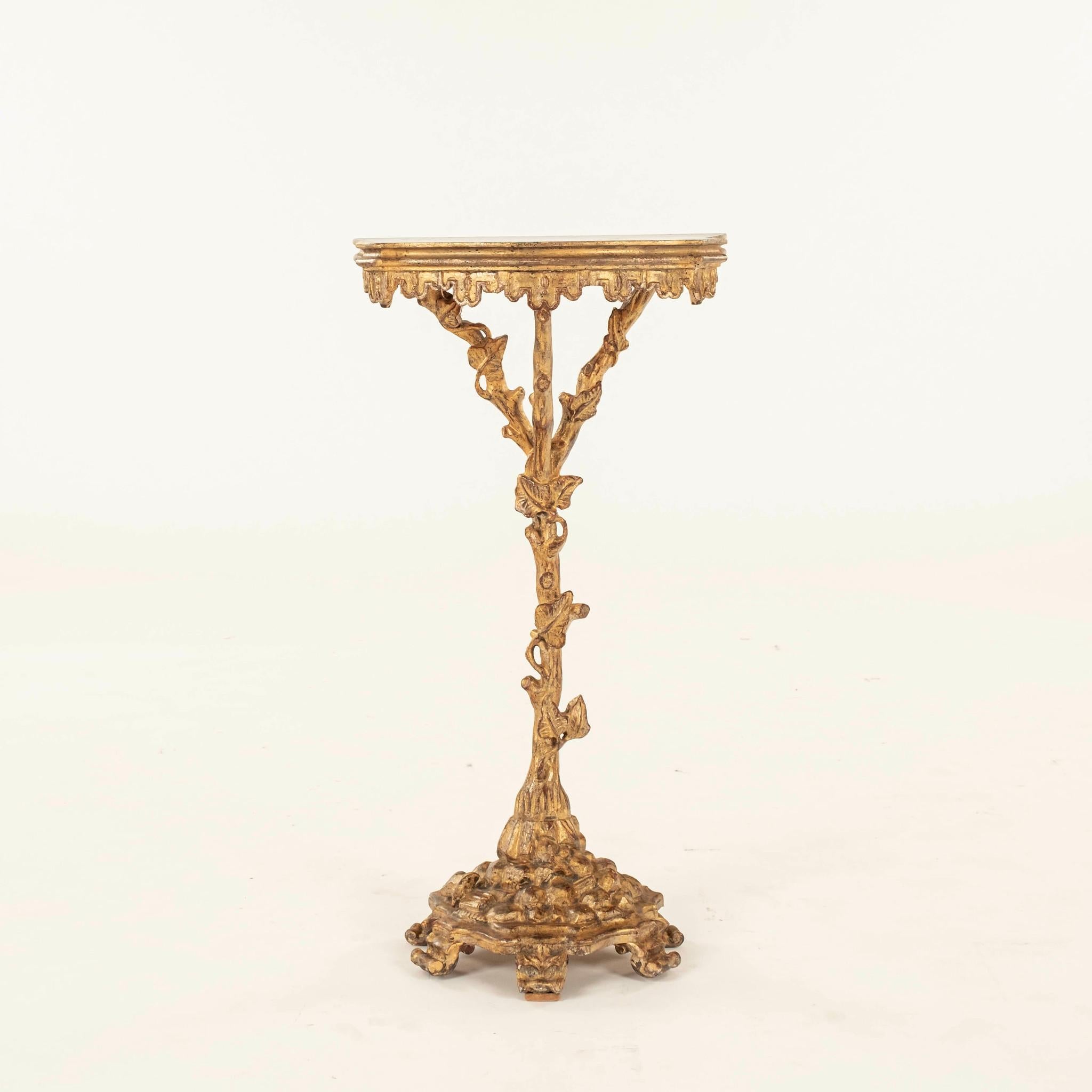 Pair petite Venetian polychromed giltwood console tables: gold and silver parcel gilt wood with a faux-painted marble top. The wood has been carved to resemble beautiful branches with vine and leaf foliage.