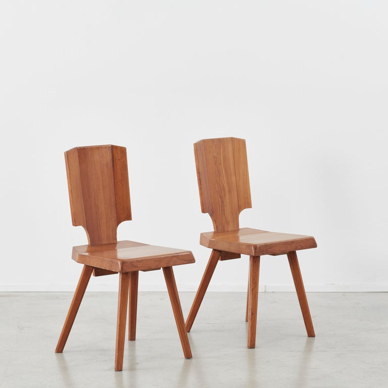 Pair of Pierre Chapo S28 dining chairs made from solid elmwood, designed in 1972, produced late 20th century. The S28 was inspired by Chapo’s travels to Alsace. He wanted to reinvent a typical Alsatian folk chair, without its decorative elements.