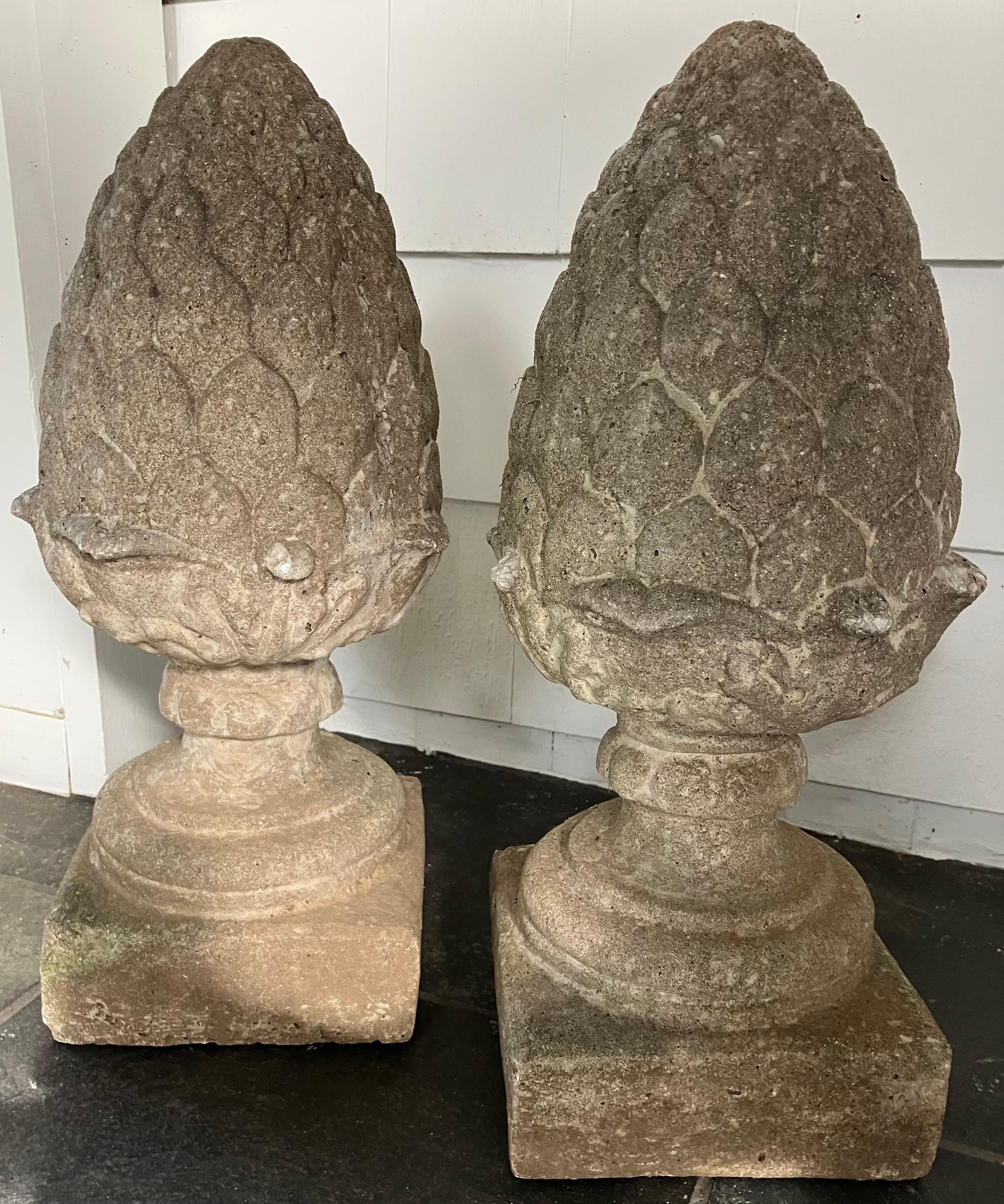 Pair pinecone cast stone finials. Vintage cast stone garden ornament finials in the form of an inverted pinecone or pineapple on socle base. Some small losses to out-turned leaves above base, otherwise in great vintage condition, United States,
