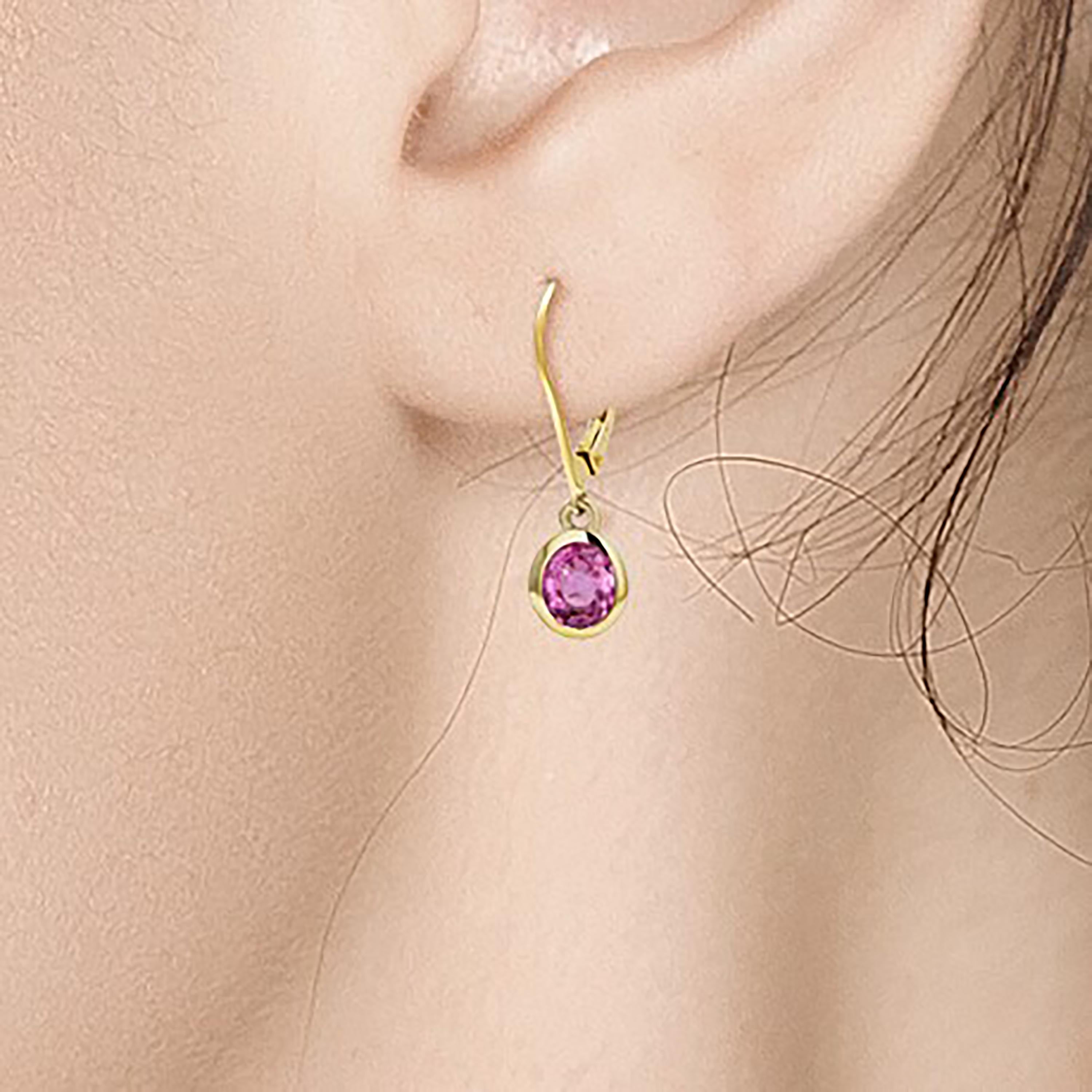 Fourteen karats yellow gold bezel set pink sapphire earrings 1
