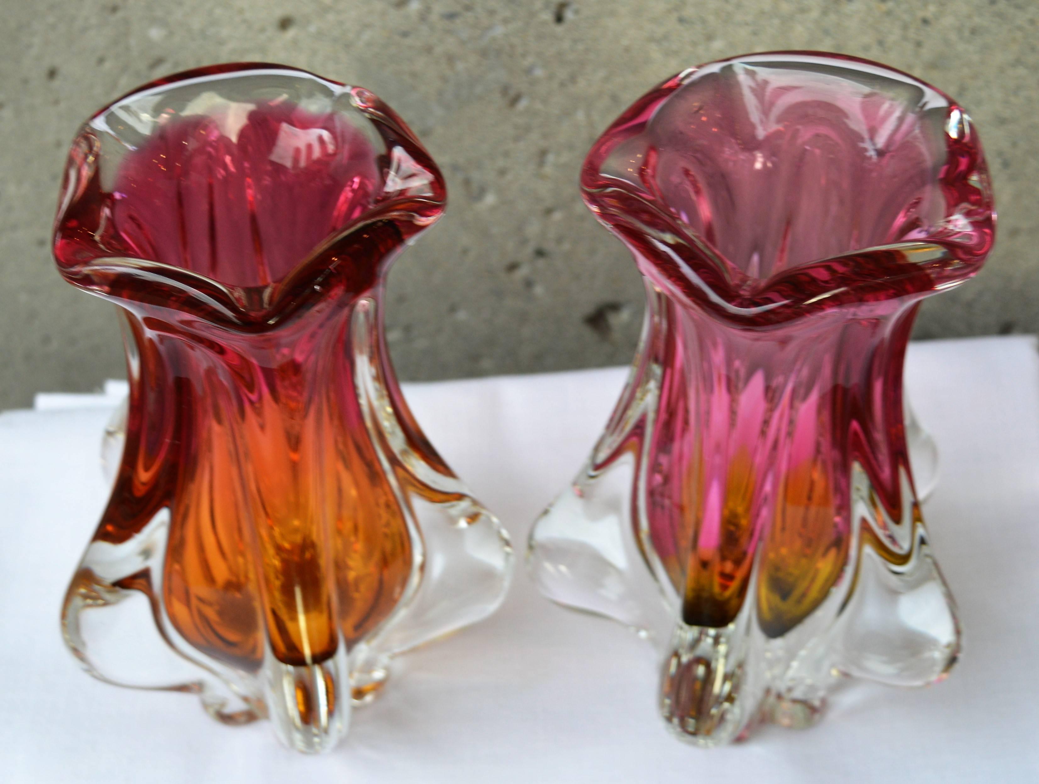 This lovely pair of Czech glass vases are a striking combination of pink and gold with clear fins and base and fluted tops. Made by Josef Hospodka for Chribska Glassworks, they are delightful and sure to be a point of interest in any decor. Rare to