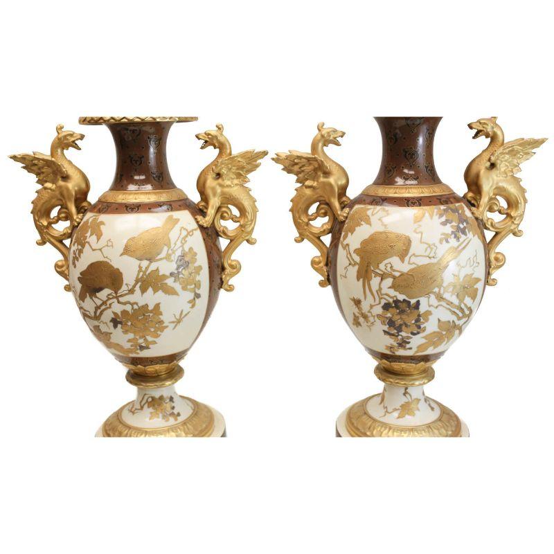 Pair Pirkenhammer porcelain Aesthetic Gold Encrusted dragon vases, c 1880

Pair Pirkenhammer porcelain Aesthetic gold encrusted double handled footed vase, circa 1880. The central image of the urns depict gold encrusted birds perched on tree