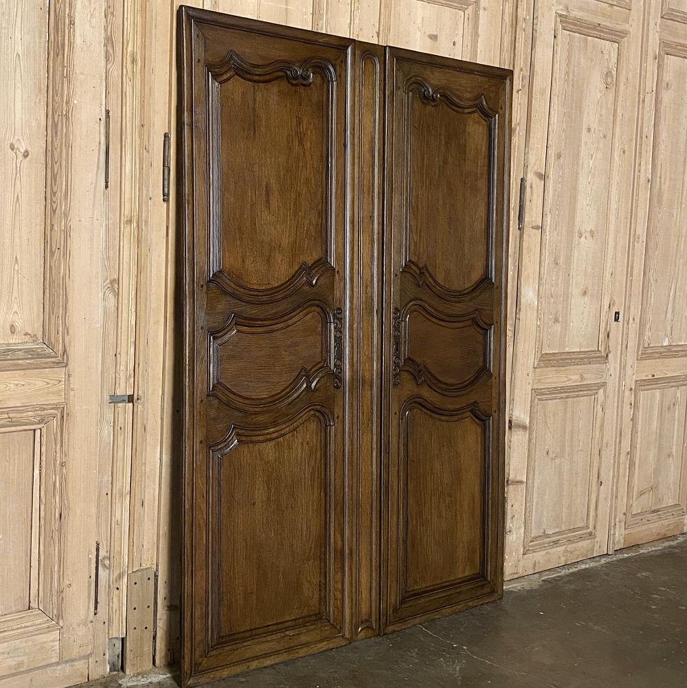 Pair of Plaquards ~ Armoire or cabinet doors, 19th century, are an excellent example of time-honored woodworking techniques handed down from generation to generation. The elegant but tailored French scrollwork of the frames houses the raised panels