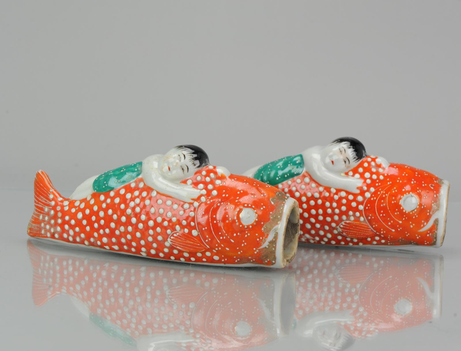 A very nice pair of wall pocket vases in the shape of Koi Carps with figures lying on their backs and seem to be transported.

Each wall vase has been manufactured from fine porcelain and hand painted in vibrant shades of orange, green, white and