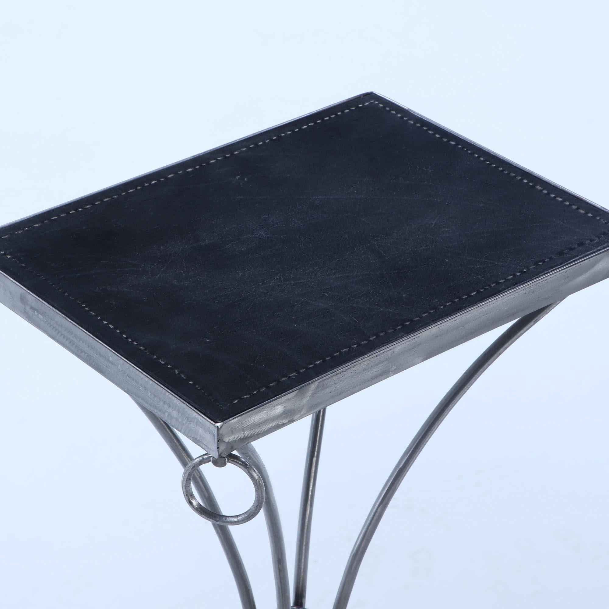 Leather Pair polished iron drinks tables with ring decoration and distressed leather For Sale