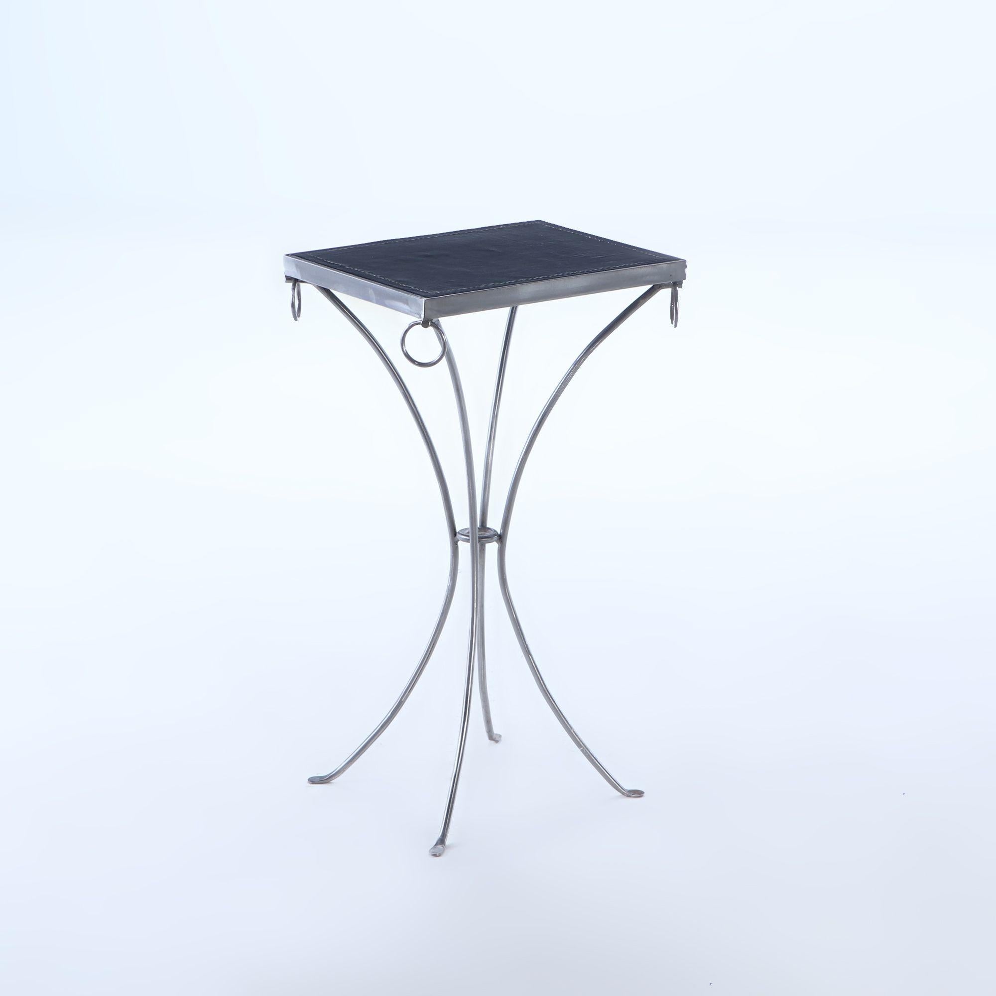 Pair polished iron drinks tables with ring decoration and black distressed leather hand stiched tops so as to look vintage.