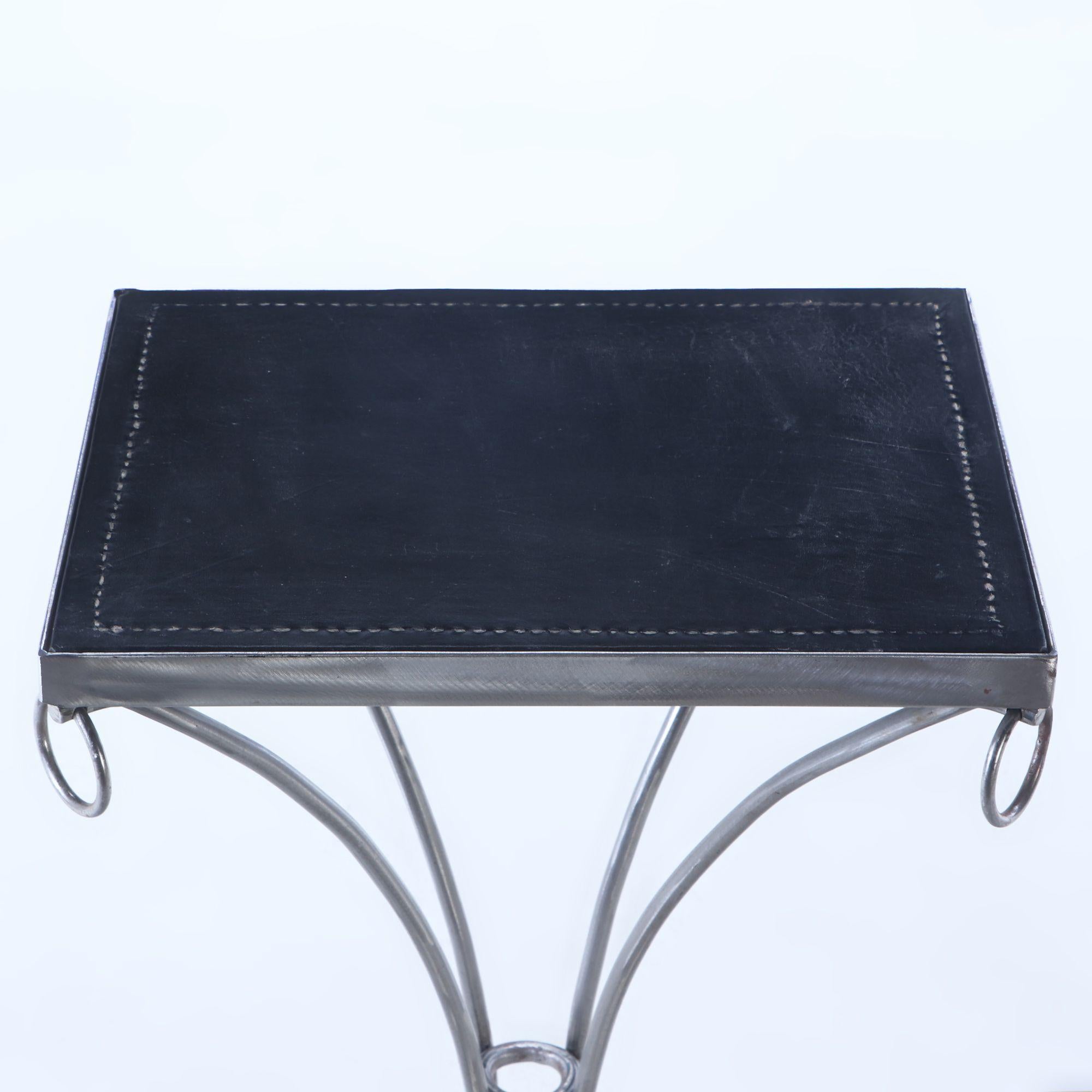 Pair polished iron drinks tables with ring decoration, distressed leather tops In Good Condition For Sale In Philadelphia, PA