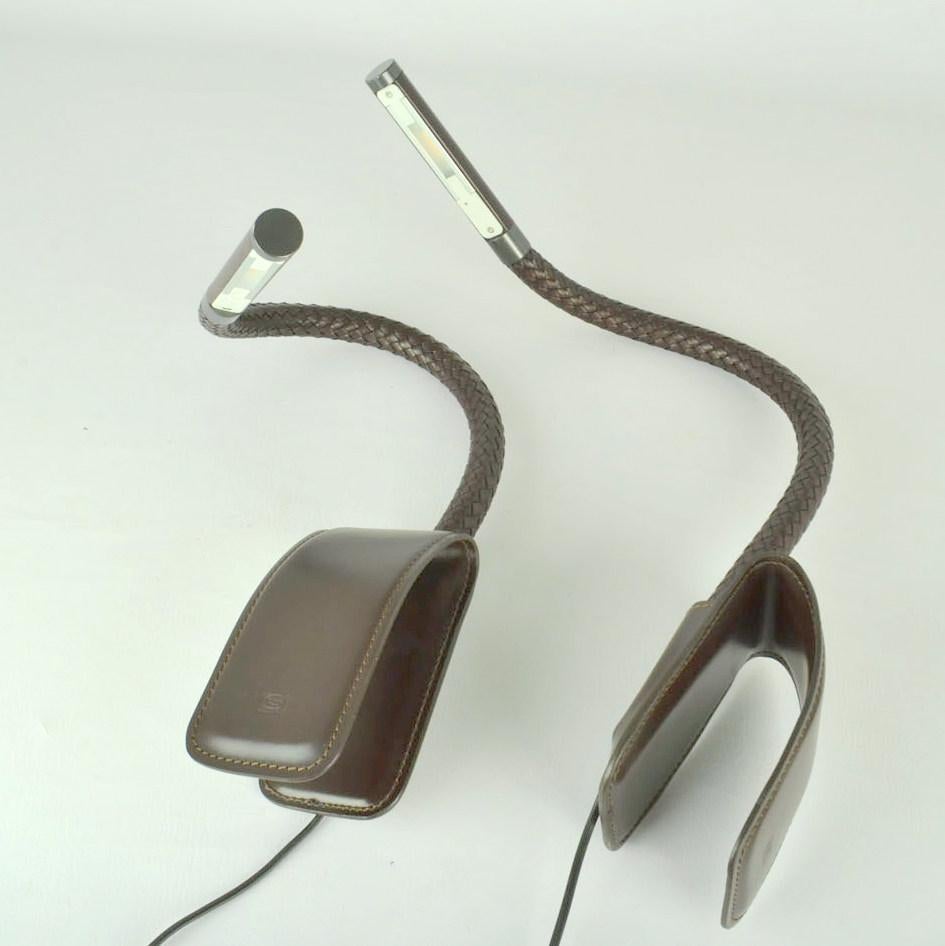 Pair of clip on reading light by Poltrona Frau Italy with touch screen with LED on flexible metal arm covered with chocolate brown pleated leather. The light clips on the back of a chair or sofa of approximate 7 cm. 
Marked with Poltrona Frau