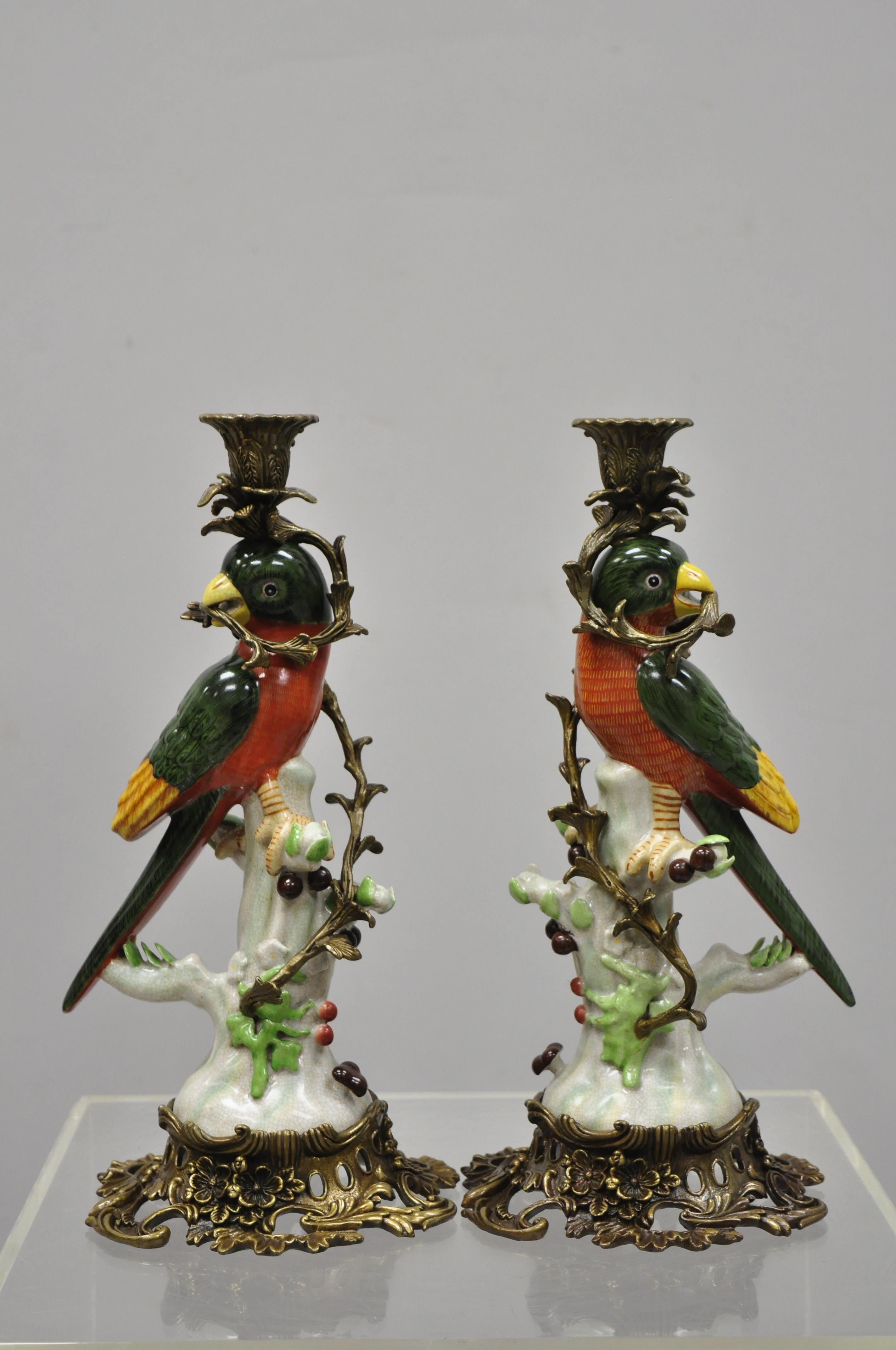 Pair of porcelain and bronze French style green and yellow parrot candlestick candleholders. Listing includes ornate brass base and ormolu, porcelain parrot figure, right and left form, circa late 20th century. Measurements: 14.5