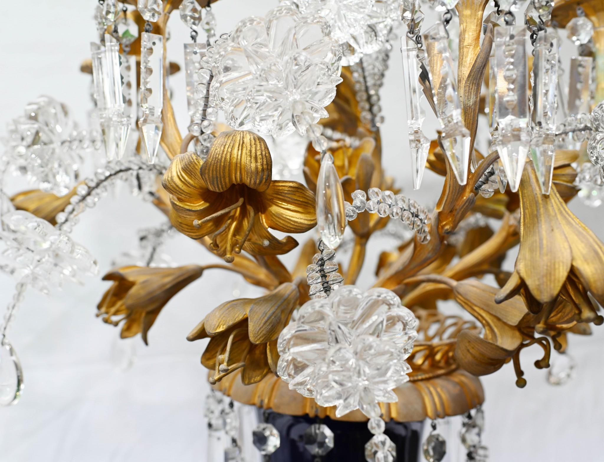 You are viewing a gorgeous pair of candelabra vases in the Louis XVI manner
Main body of urn is blue porcelain offset by gilt fixtures
Features crystal lustral drops hanging down from the candelabra branches
Good size at just under three feet tall -