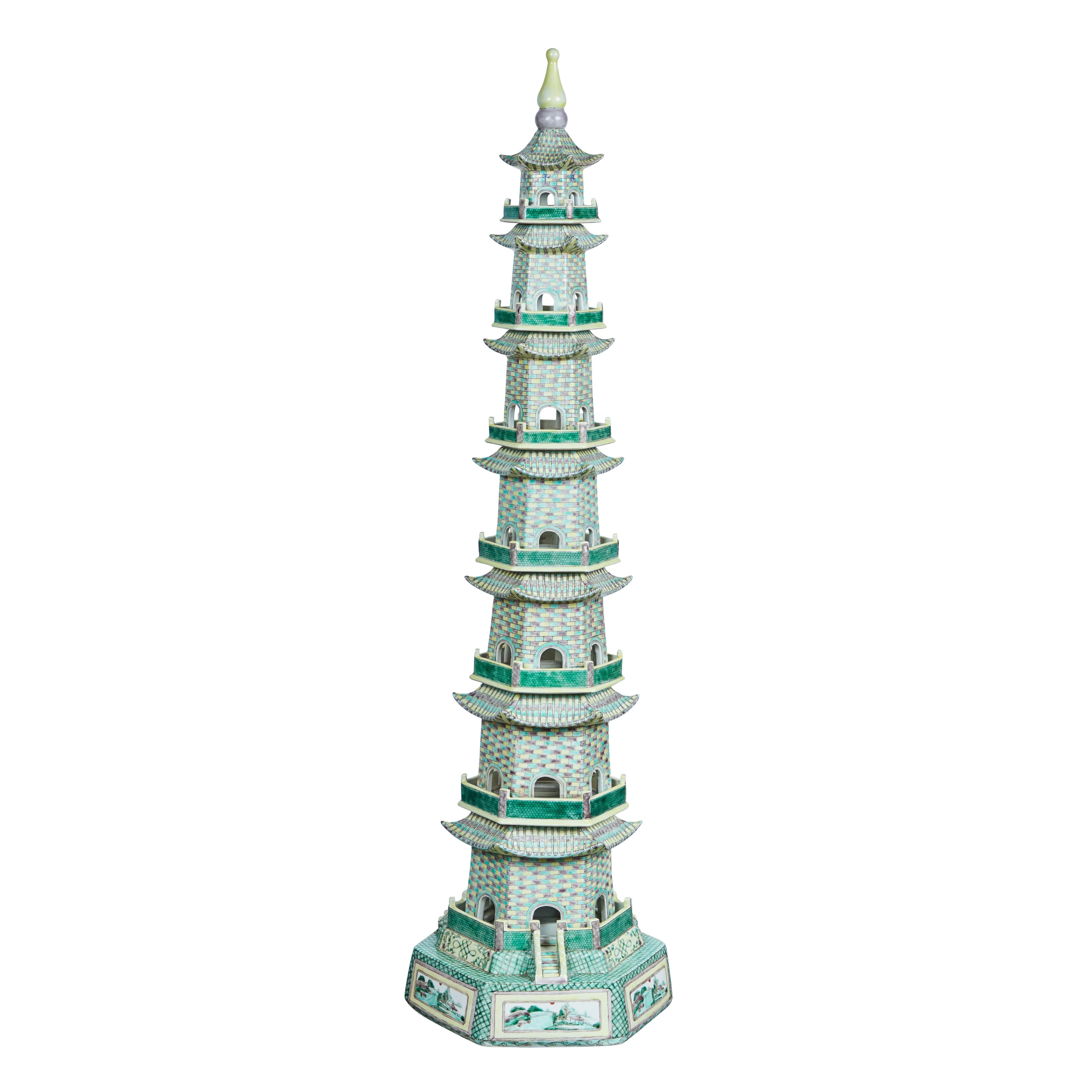 A pair of 6 sided, seven-tier, hand-painted porcelain pagodas in greens and pastels on a bases decorated with a landscape scene.
Each section is an individual piece.