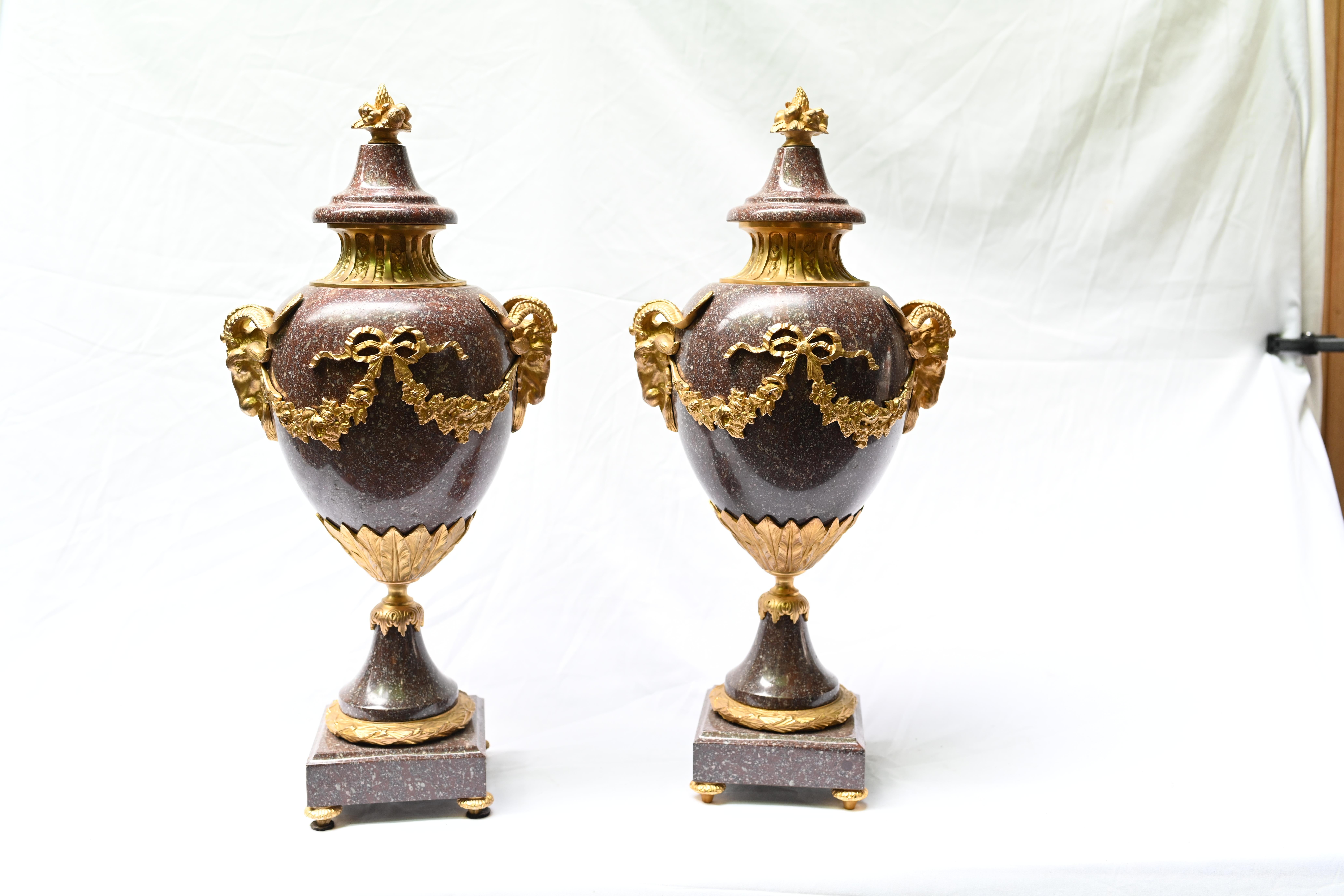 Stunning pair of French antique cassolette urns in porphyry - a type of marble
We date these to circa 1880 and they are decorated with original gilt mounts including distinctive rams heads
These are a refined and classical pair of amphora form
Other