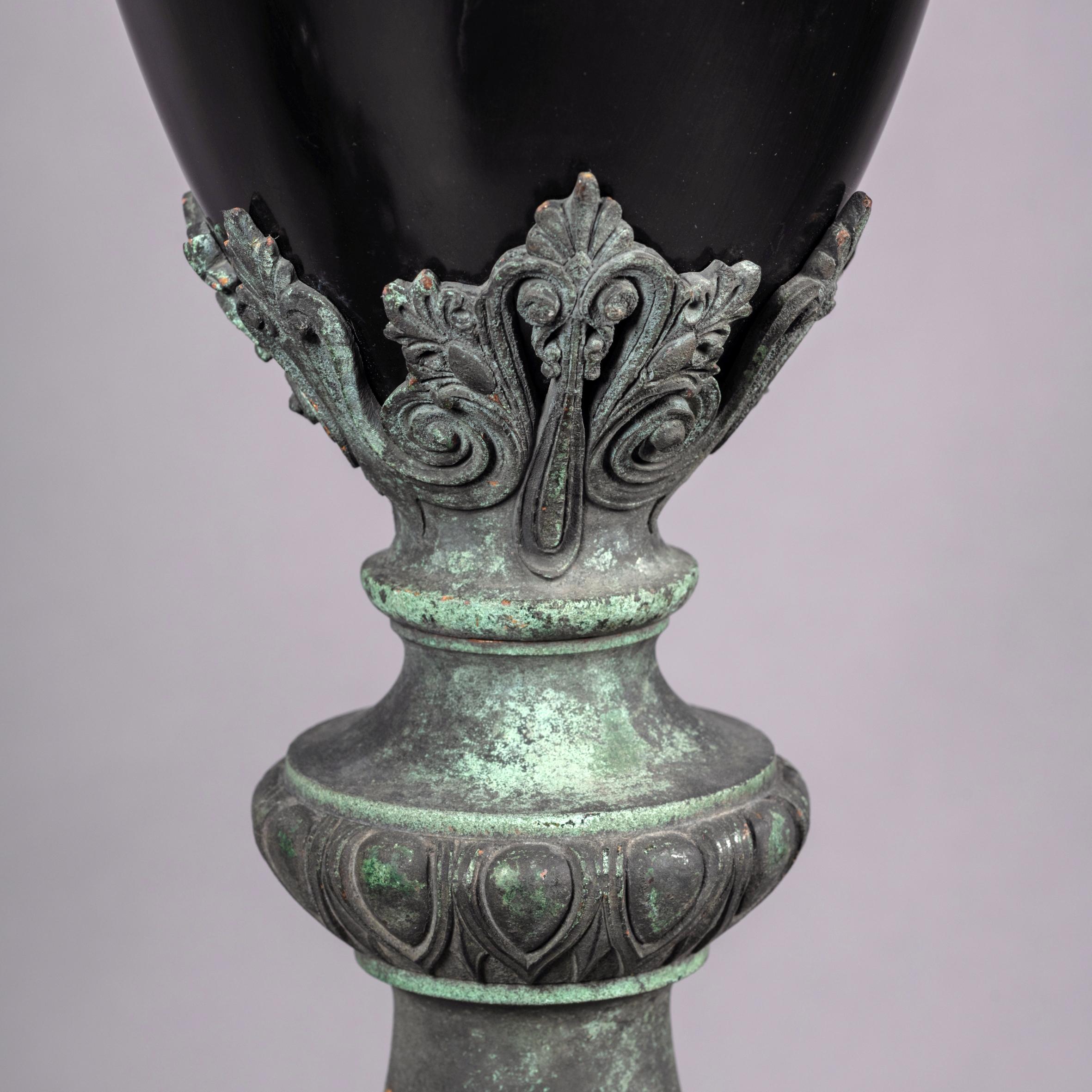 A pair of bronze and Belge Noir marble porte-torchères in the manner of Barbedienne. 

French, circa 1870.