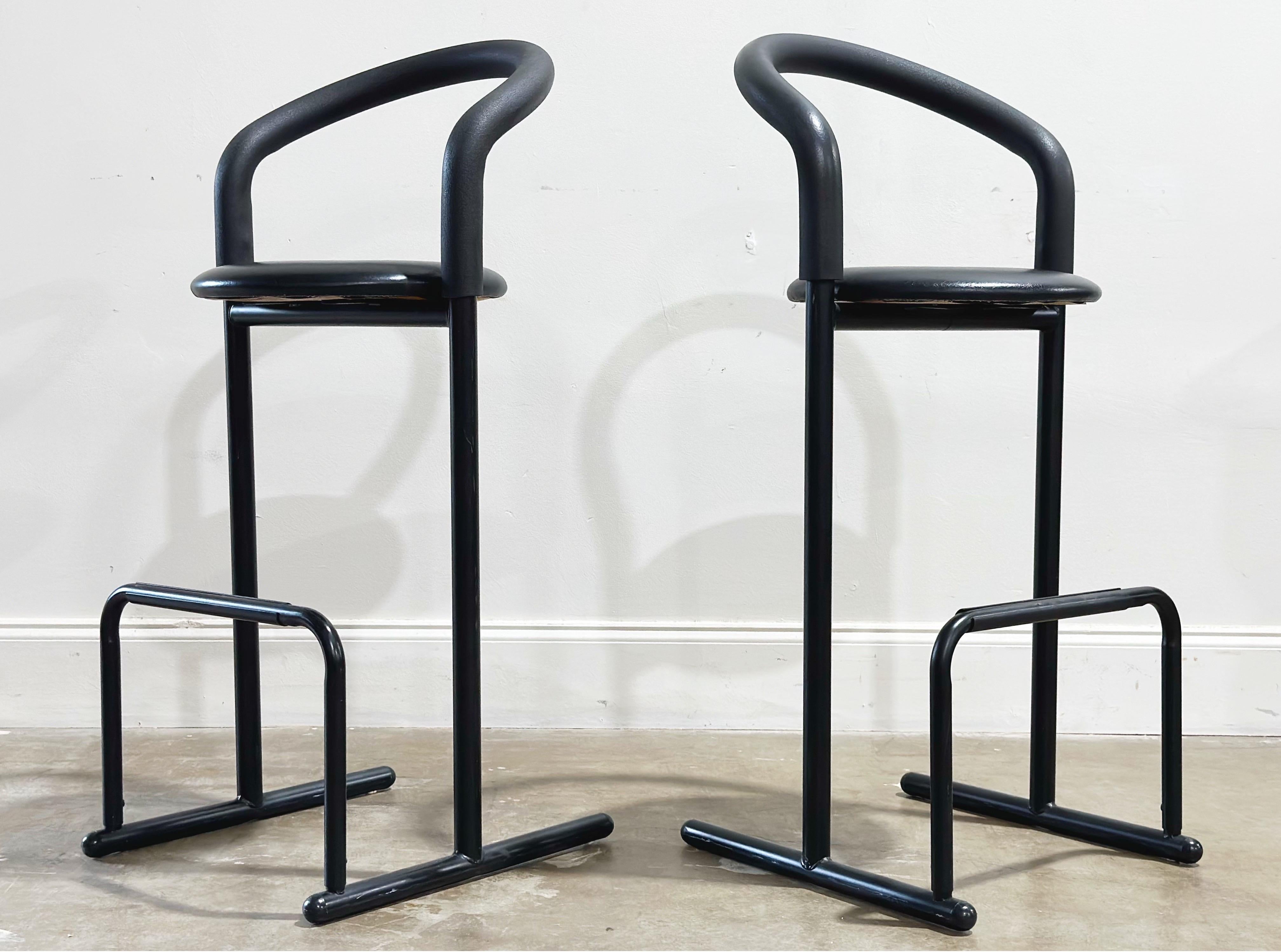 Pair of vintage post modern barstools by Les Industries Amisco - Canada circa 1980s. Bar height. Black metal frames with foam padded back/arm rests and black naugahyde seats. 
Excellent original condition - these stools look to have been hardly, if