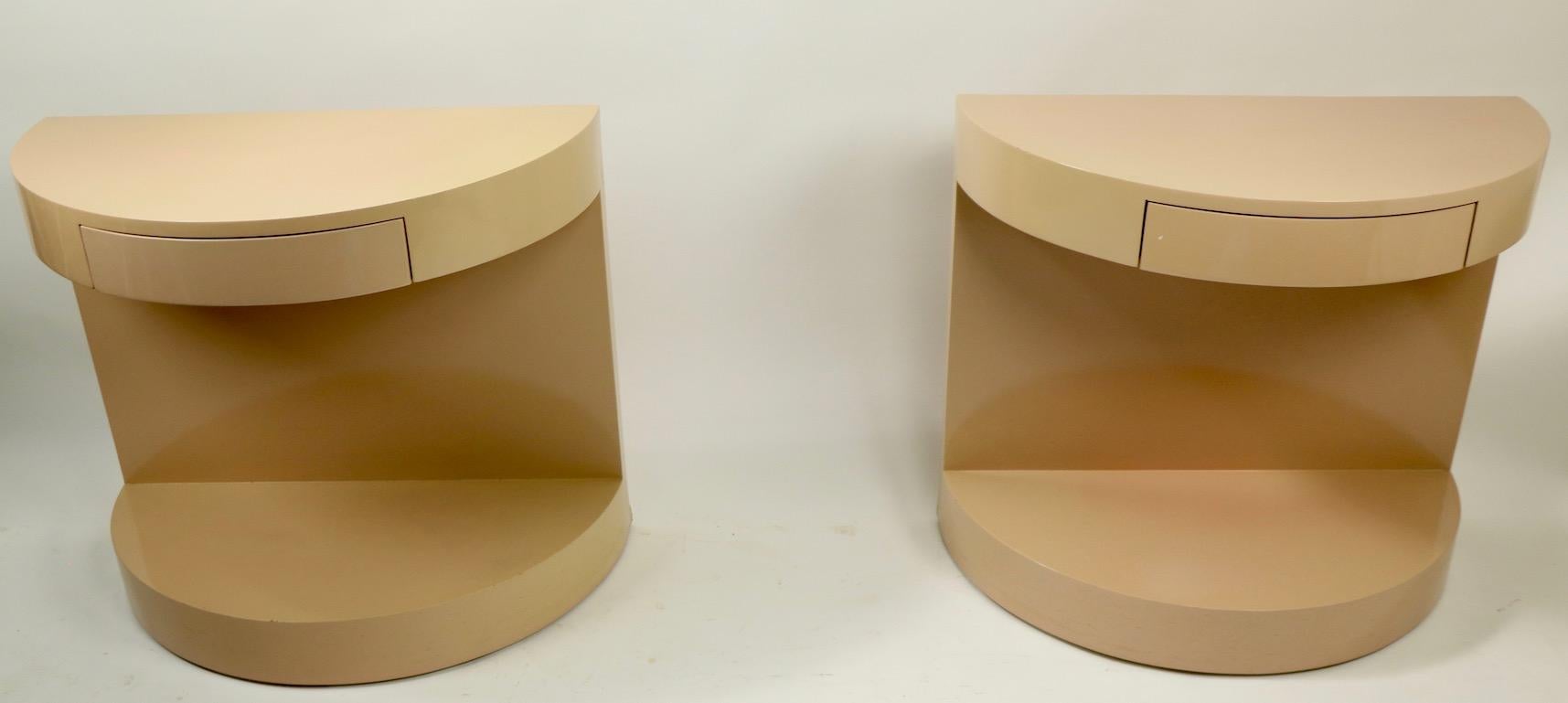 Pair of one drawer Postmodern Art Deco Revival night stands, in original blush lacquer finish, circa 1970s-1980s. Both are in good, original condition, each shows minor wear including inconsequential bruising to lower back corner and ( tiny ) loss