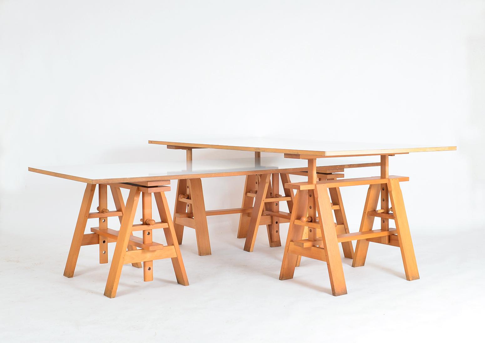 A rare opportunity to buy a pair of Leonardo desks designed by Achille Castiglioni for Zanotta, Italy. Reversable wooden top with white melamine on both sides, the easel base is of solid beech with pegged mortise and tenon joints. The trestles are