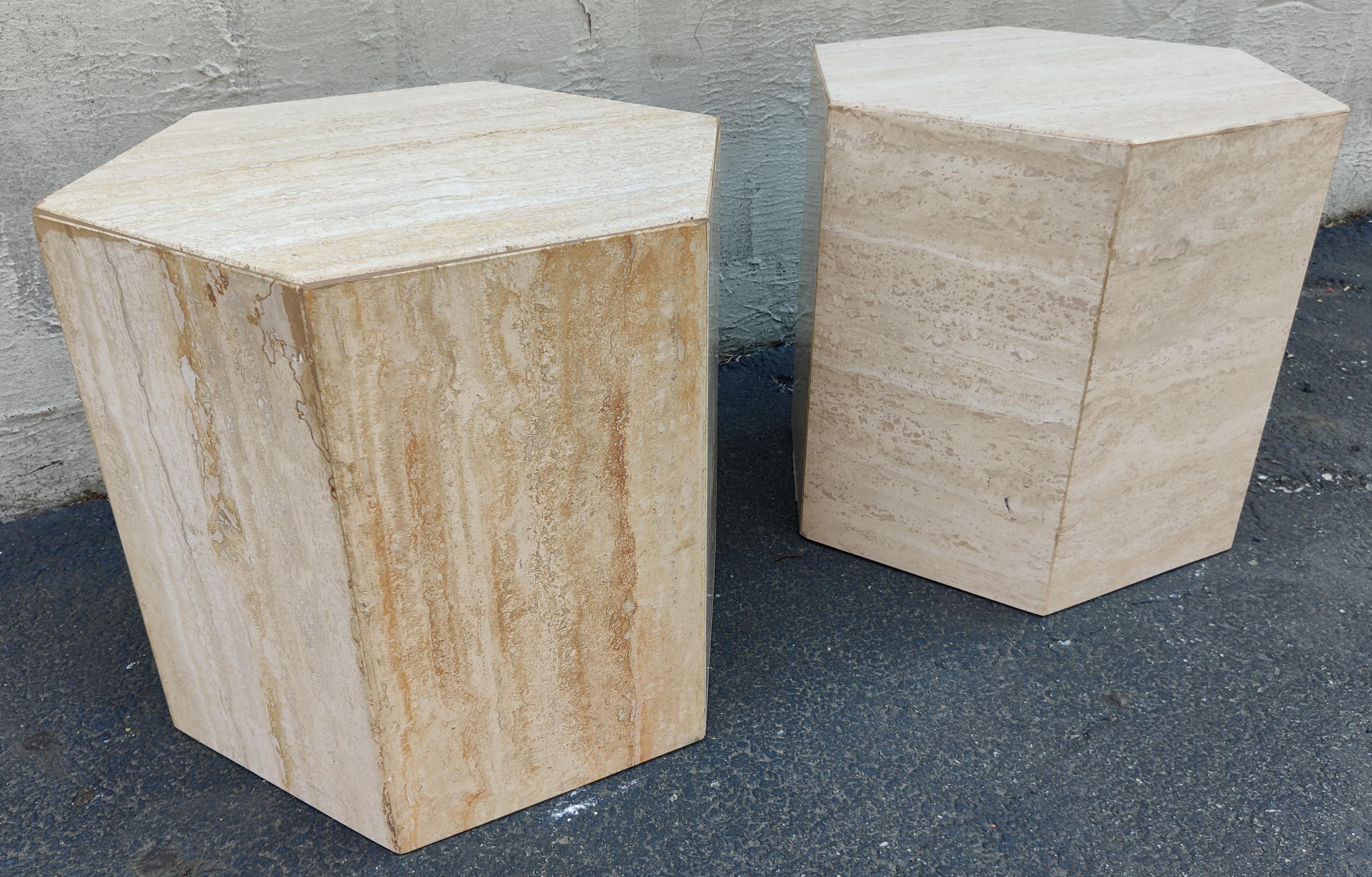 Pair of Italian travertine marble haxagonal side tables or pedestals. The polished travertine is beige and cream colored with beautiful variation. Notice in some areas the grain develops a red or rust-colored hue, which adds to its beauty and