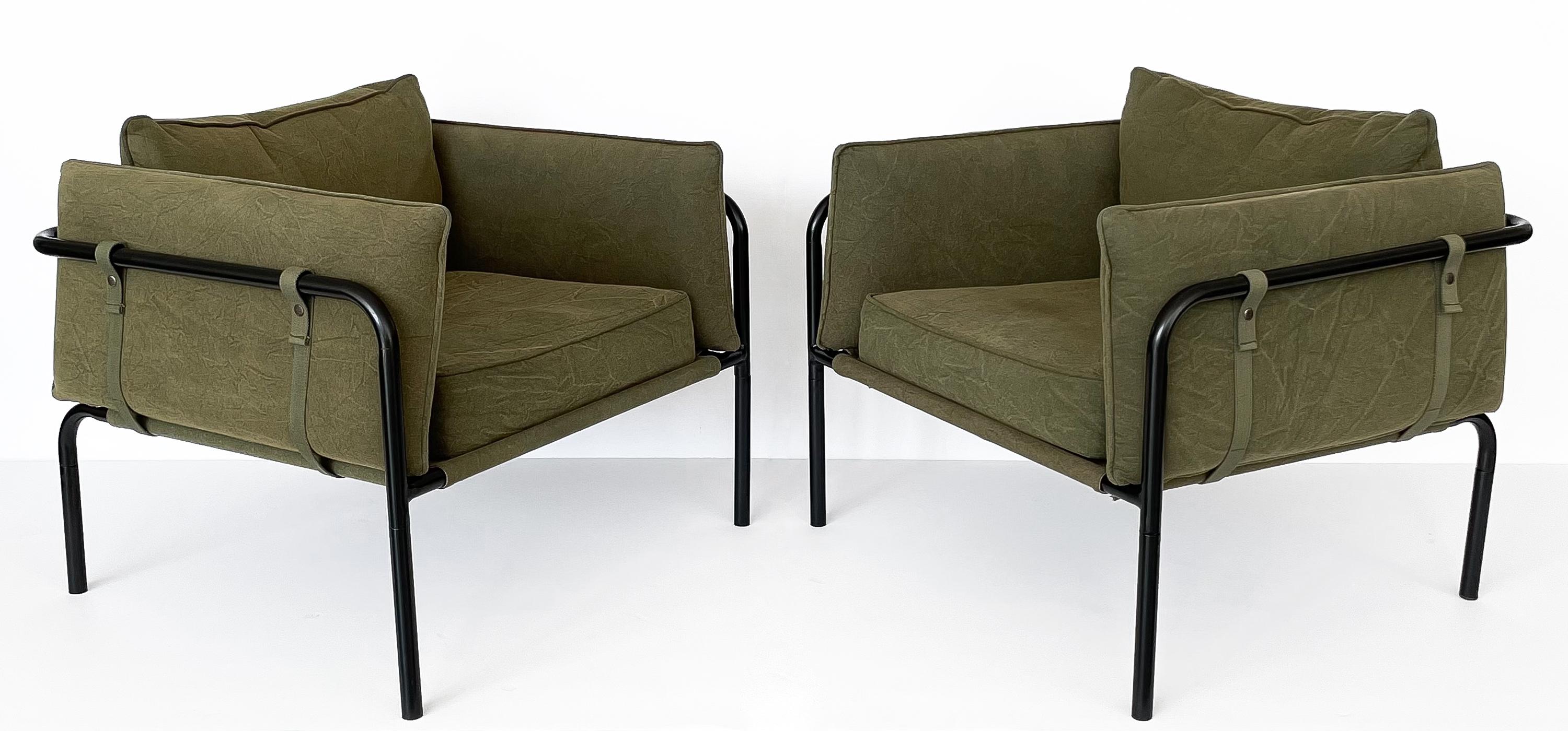 Pair of Postmodern lounge chairs with canvas upholstery, circa late 20th century. This pair of chairs feature a black enameled tubular framework with canvas sling seat, canvas cushions and woven straps with snap buttons. A modern take on a classic