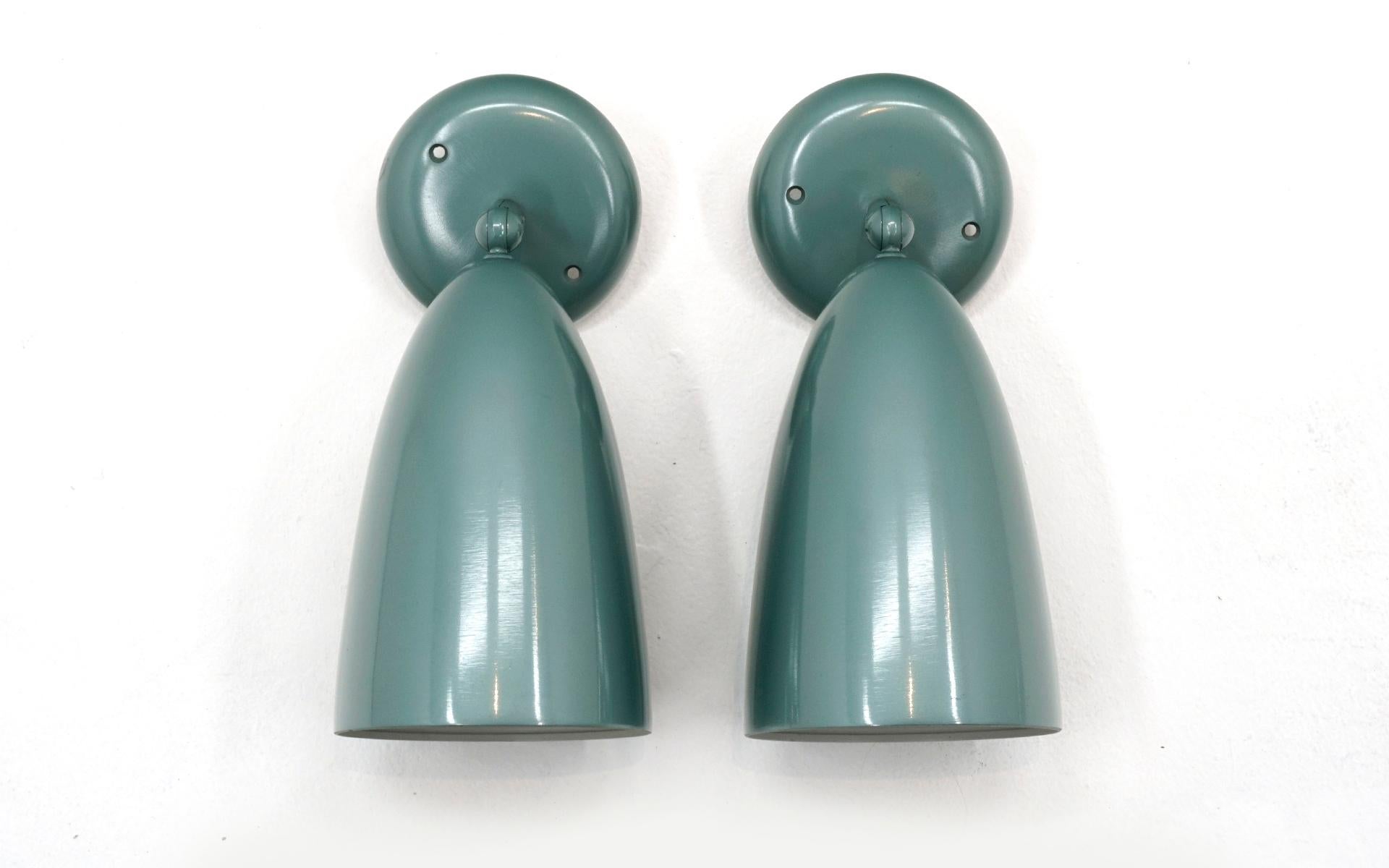 Matching pair of Prescolite wall sconces / light fixtures in mint condition. These are new old stock with the original boxes and hardware. These have never been used and are in new condition. Beautiful blue-green, teal color. Ready to install and