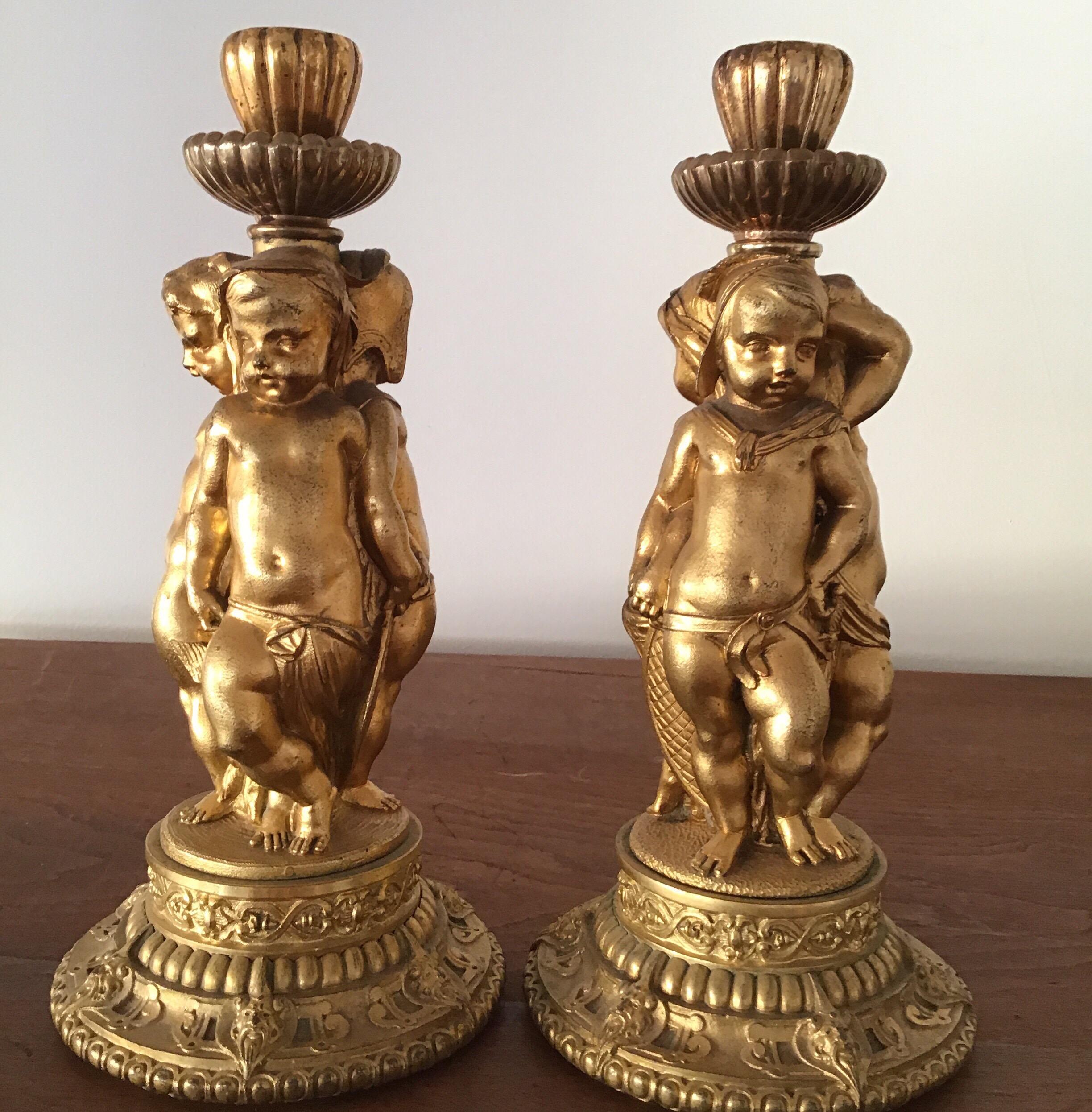 Pair of bronze ormolu  figural cherubs candlesticks Louis XV1  late 19th century mercury gilded with exquisite casting and details.