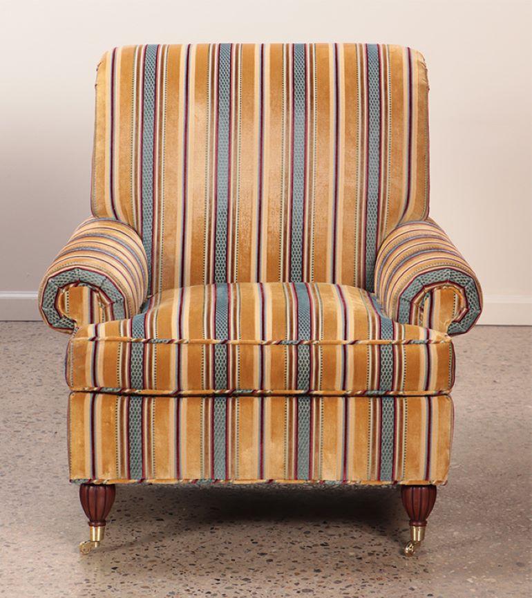 American Pair quality upholstered club chairs in striped fabric having brass castors