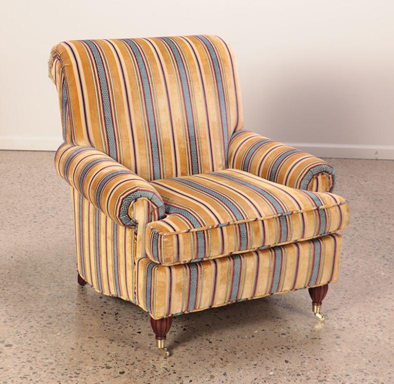 Brass Pair quality upholstered club chairs in striped fabric having brass castors