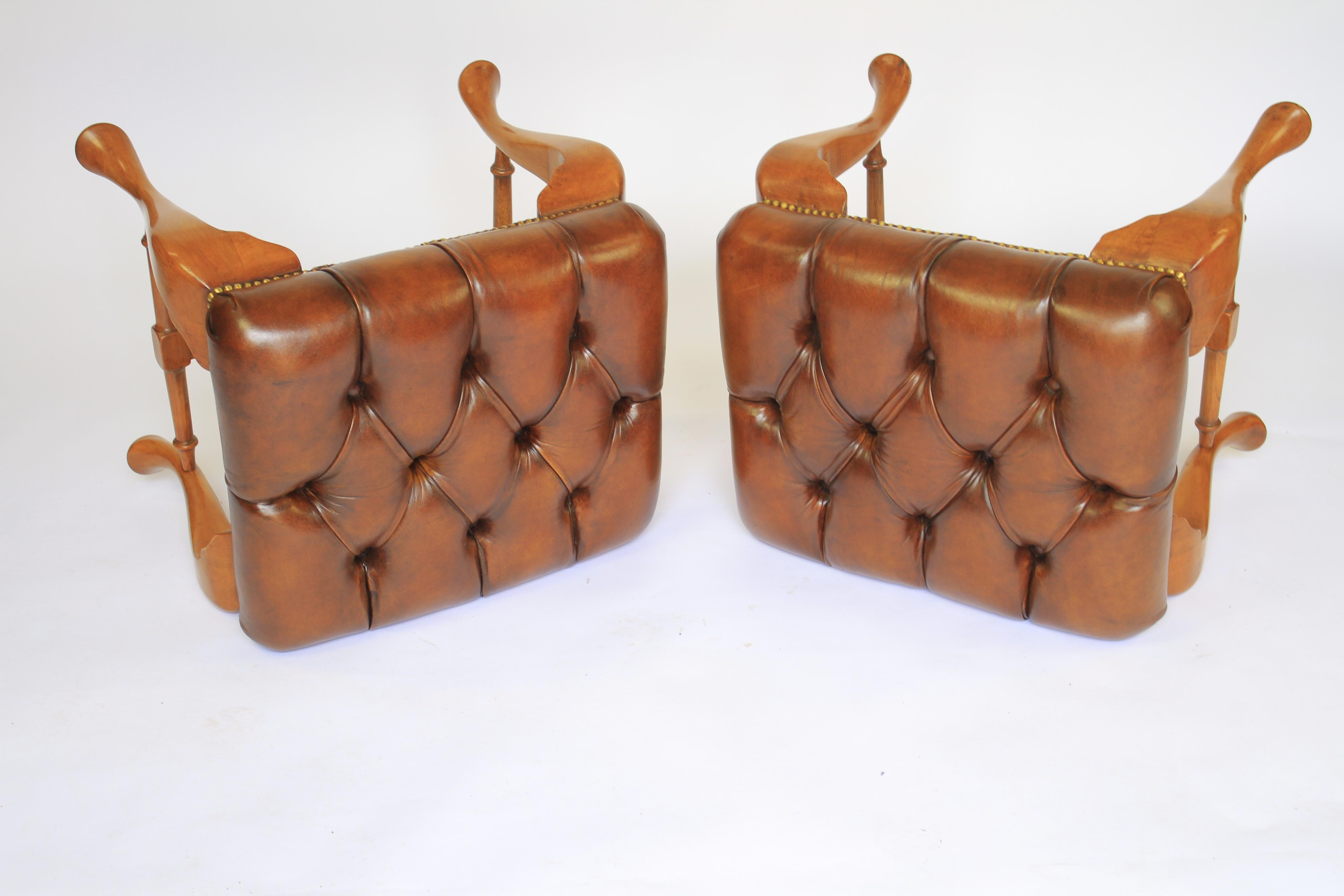 Pair Queen Anne Revival Walnut Foot Stools circa 1920s
Deep buttoned leather seats. recently 
covered in leather & coloured to chestnut
Walnut Cabriole shaped legs with turned H cross stretcher 
Good quality pair
Recently Polished