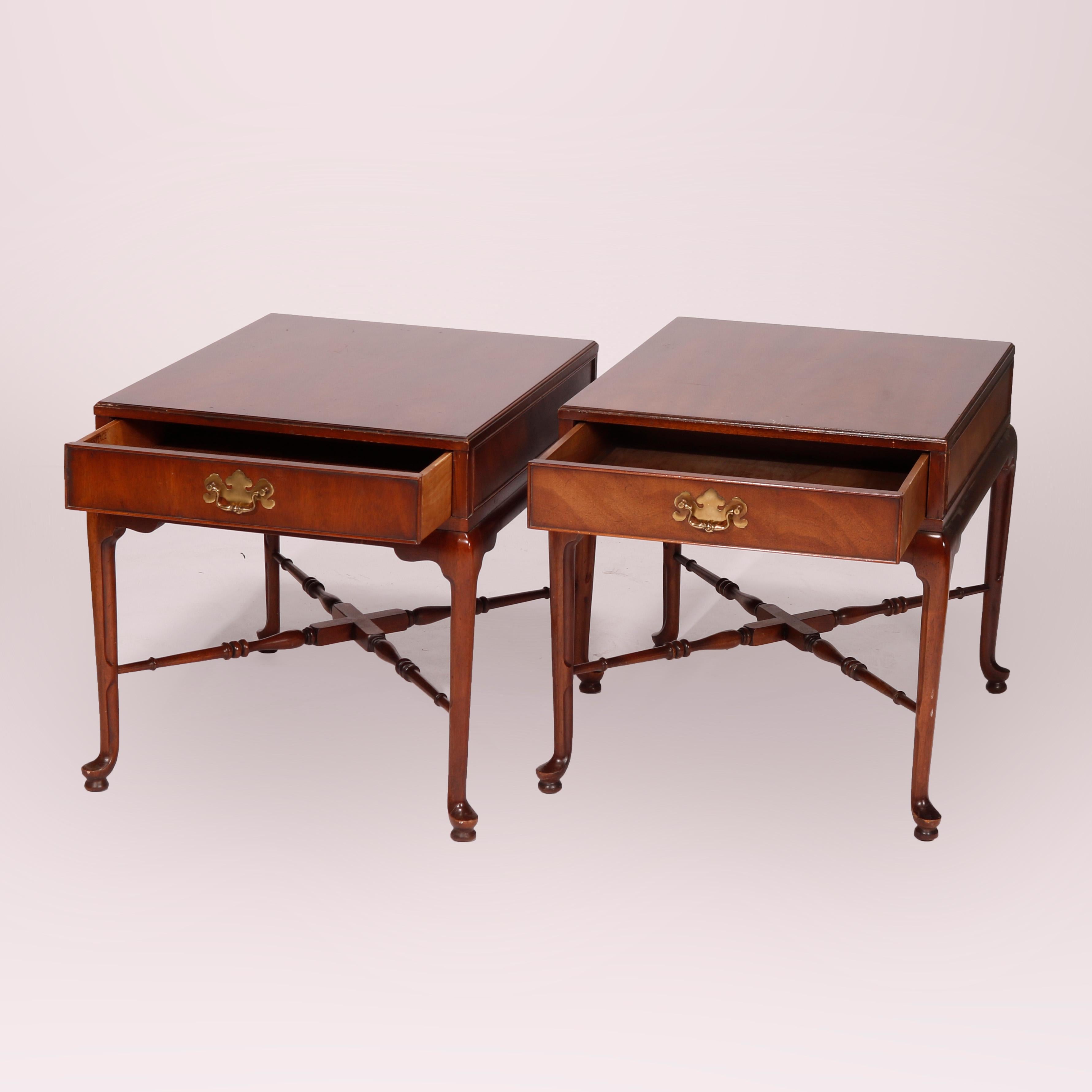 A matching pair of Queen Anne style side stands by Heritage of the Signers Collection and retailed by B. Altman & Co. of New York offer walnut construction with cases having single drawers, riased on cabriole legs with pad feet and turned