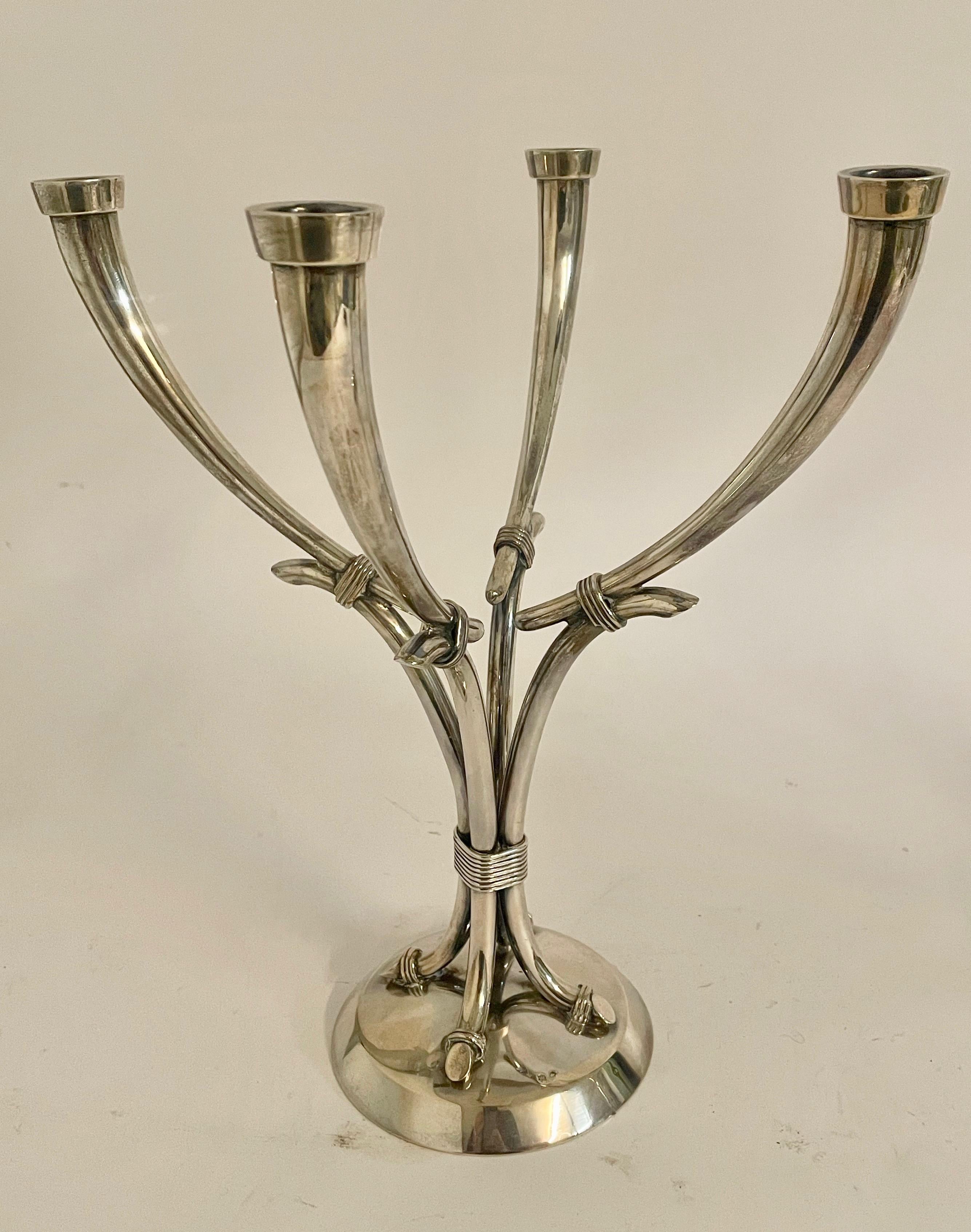 Pair of elegant Spanish silver candelabra with four arms, stamped with a silver mark to the top and 'Rafael Torres' to the base, along with 'Plata De Ley' (meaning sterling silver) and the initial M to the underside. This pair of 1980s modernist