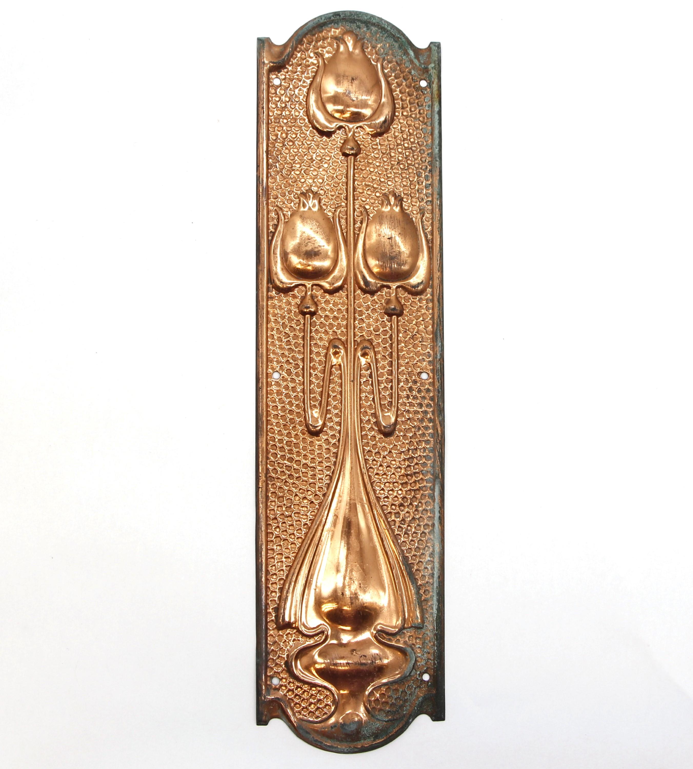 These copper plated brass push plates with a hammered Art Nouveau design showcase tulip designs and add a touch of elegance to doors. They are in good condition, with some surface wear. Priced as a pair. Please note, this item is located in our