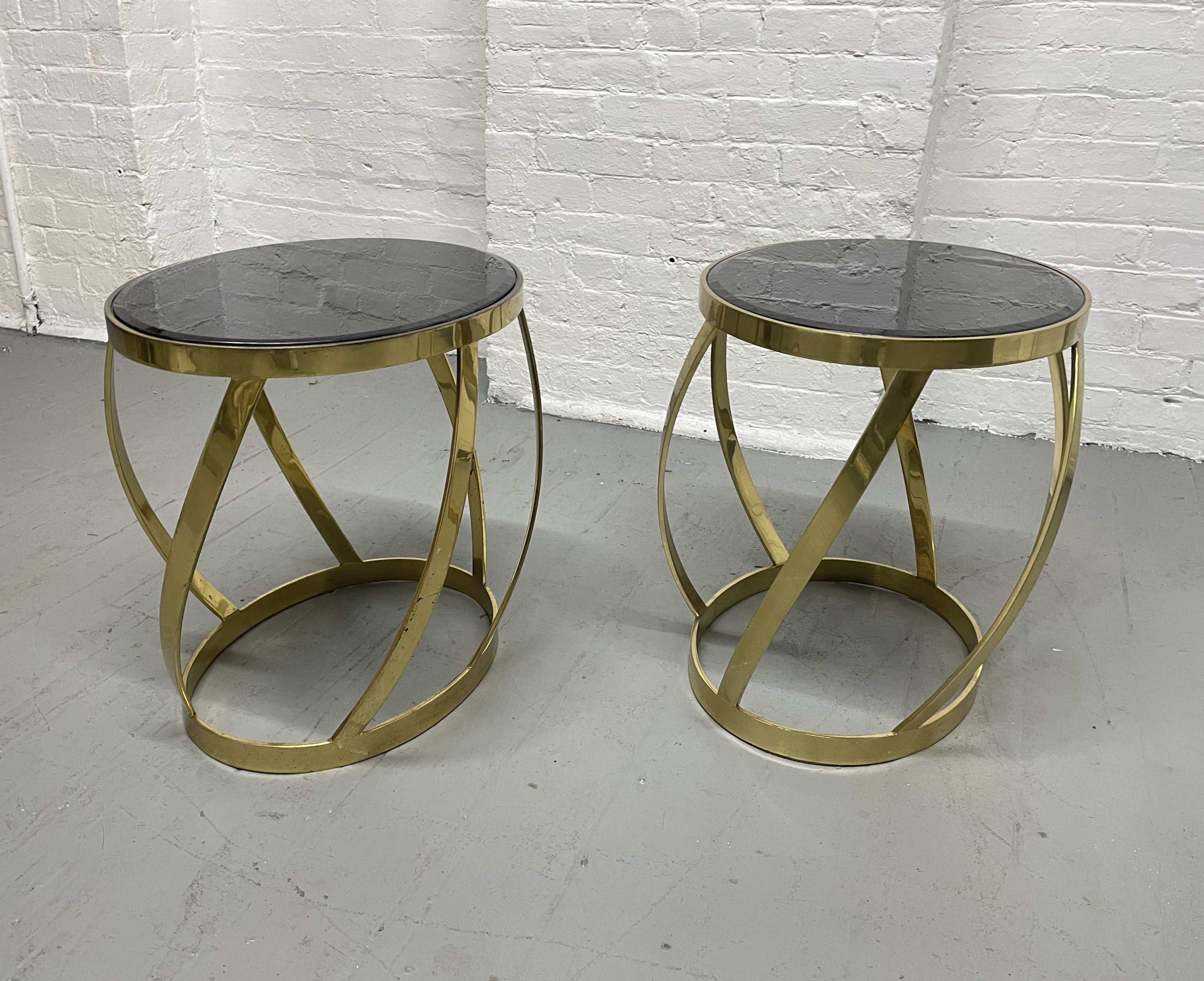 Pair of rare oval onyx brass side tables by Karl Springer. Heavy brass tables with an onyx beveled insert top. One table is slightly taller and wider.
Taller: 17.75H x 17.25W x 15D.
Smaller: 17.5H x 19.5W x 14.75D.