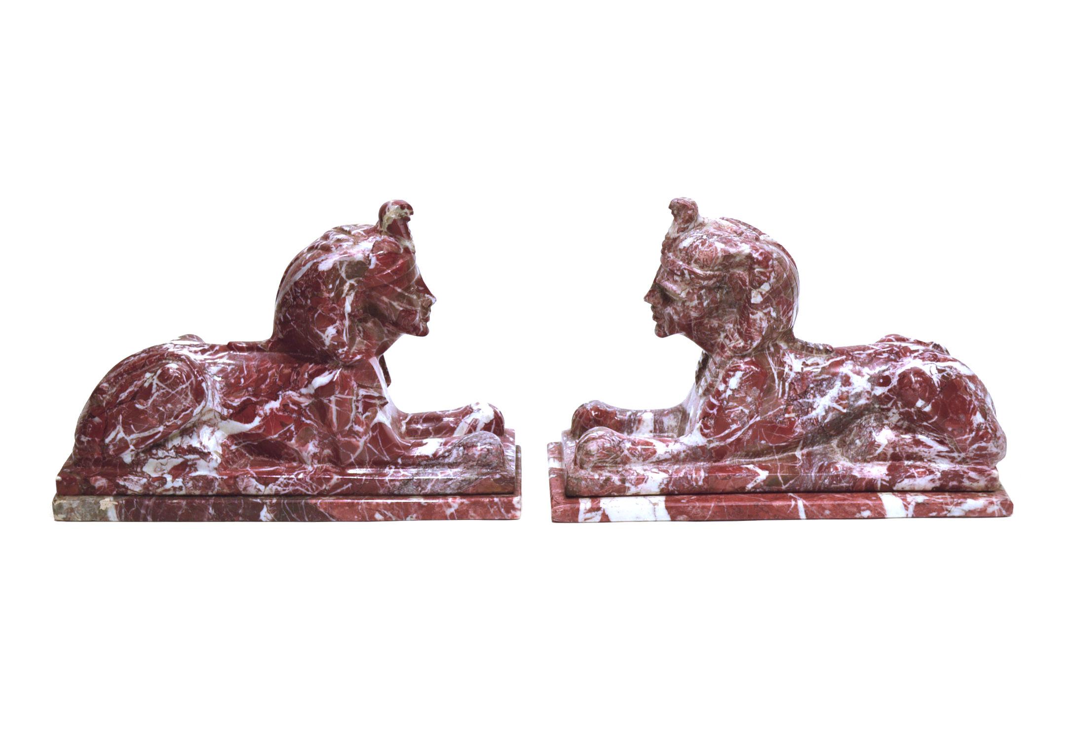 Pair of red and white marble sphinx.