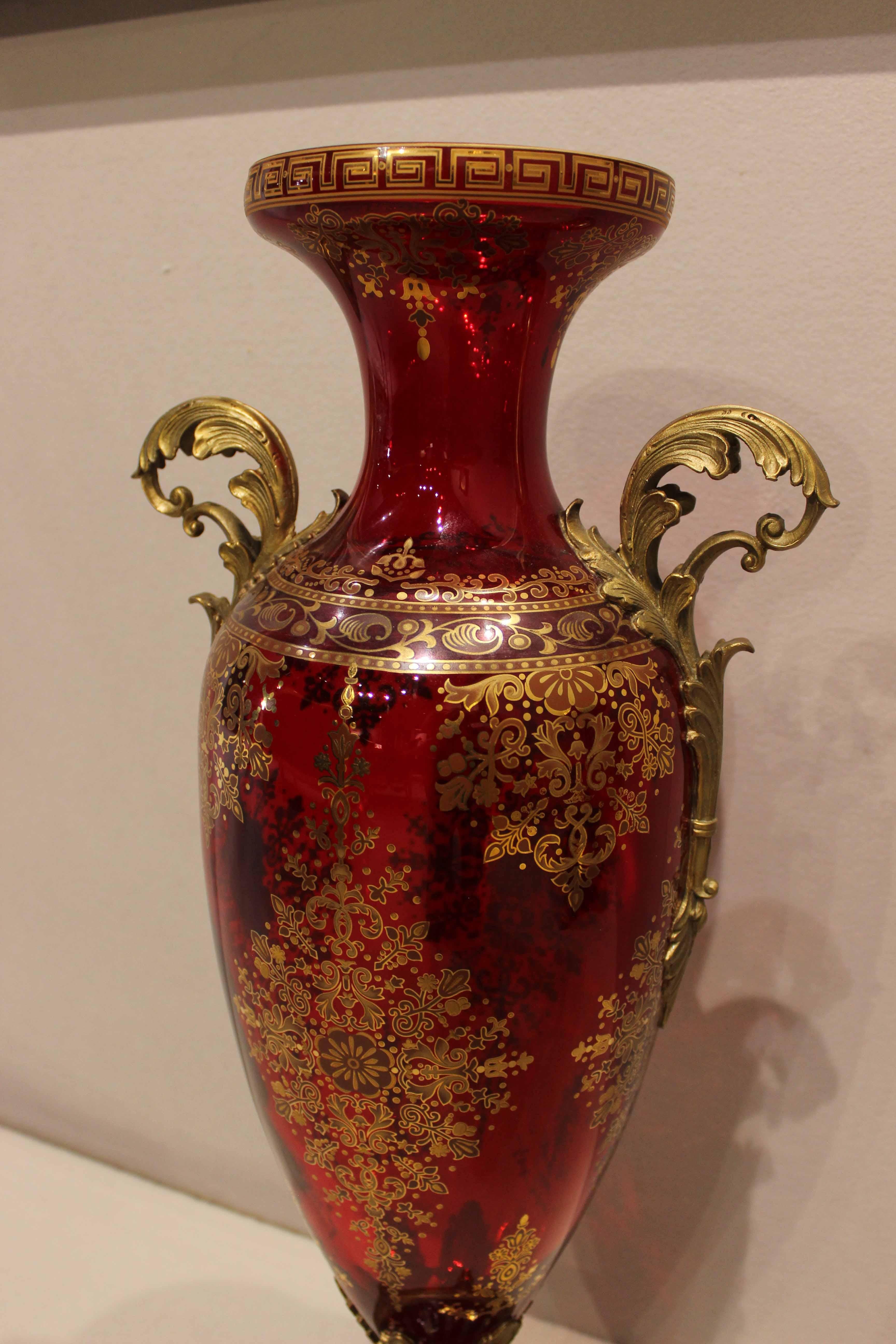 Pair of crystal de Boheme vases, red and gold cut crystal, with brass handles and base.