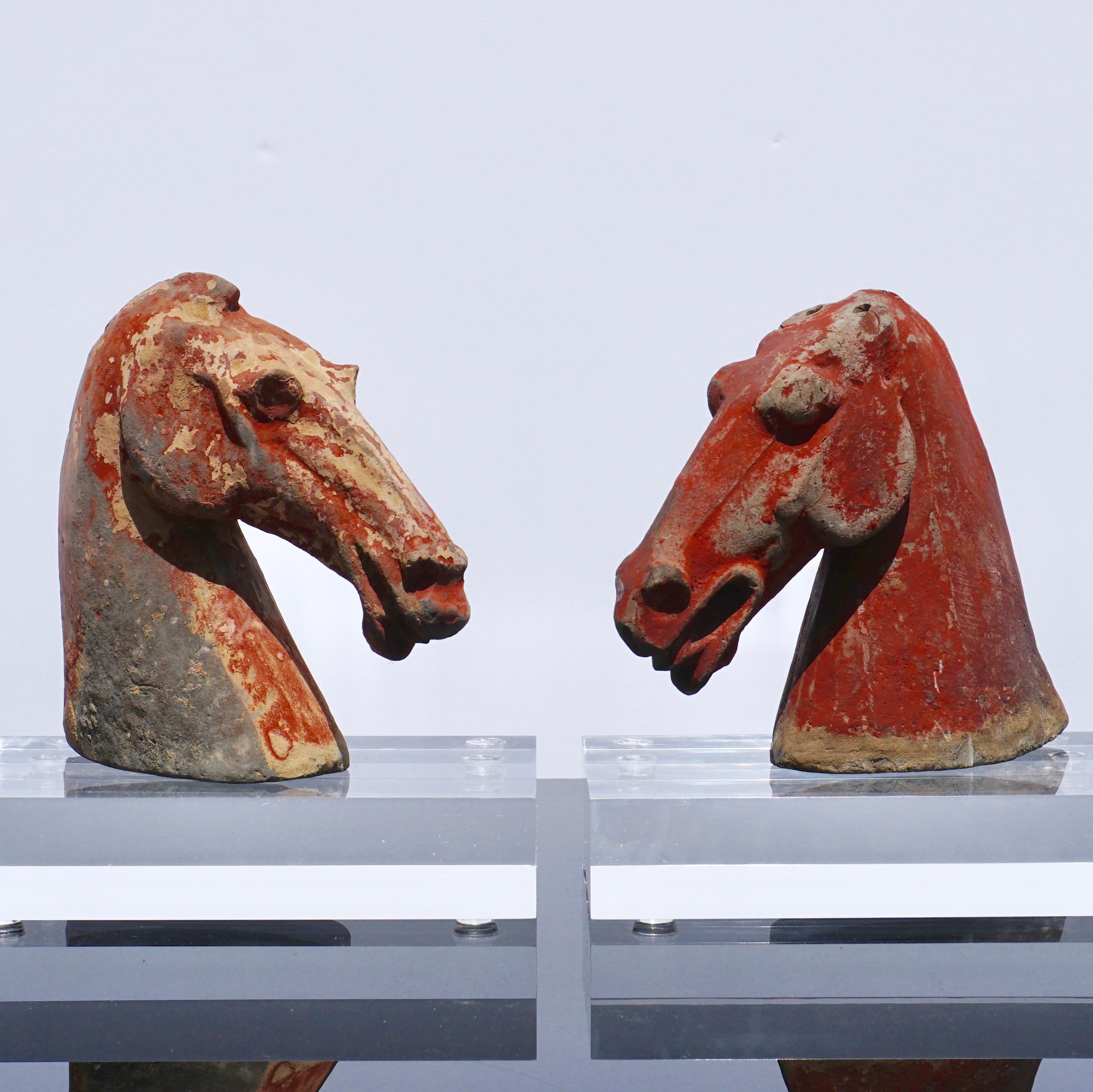 Pair of Chinese Han dynasty horse heads
Han dynasty (206 BC-220 AD) earthenware gray pottery

Each approximate measures: 6 inches high. 6.5 inches wide. 2.5 inches depth

Accompanied by clear plexiglass display stands. No TL tests but guaranteed