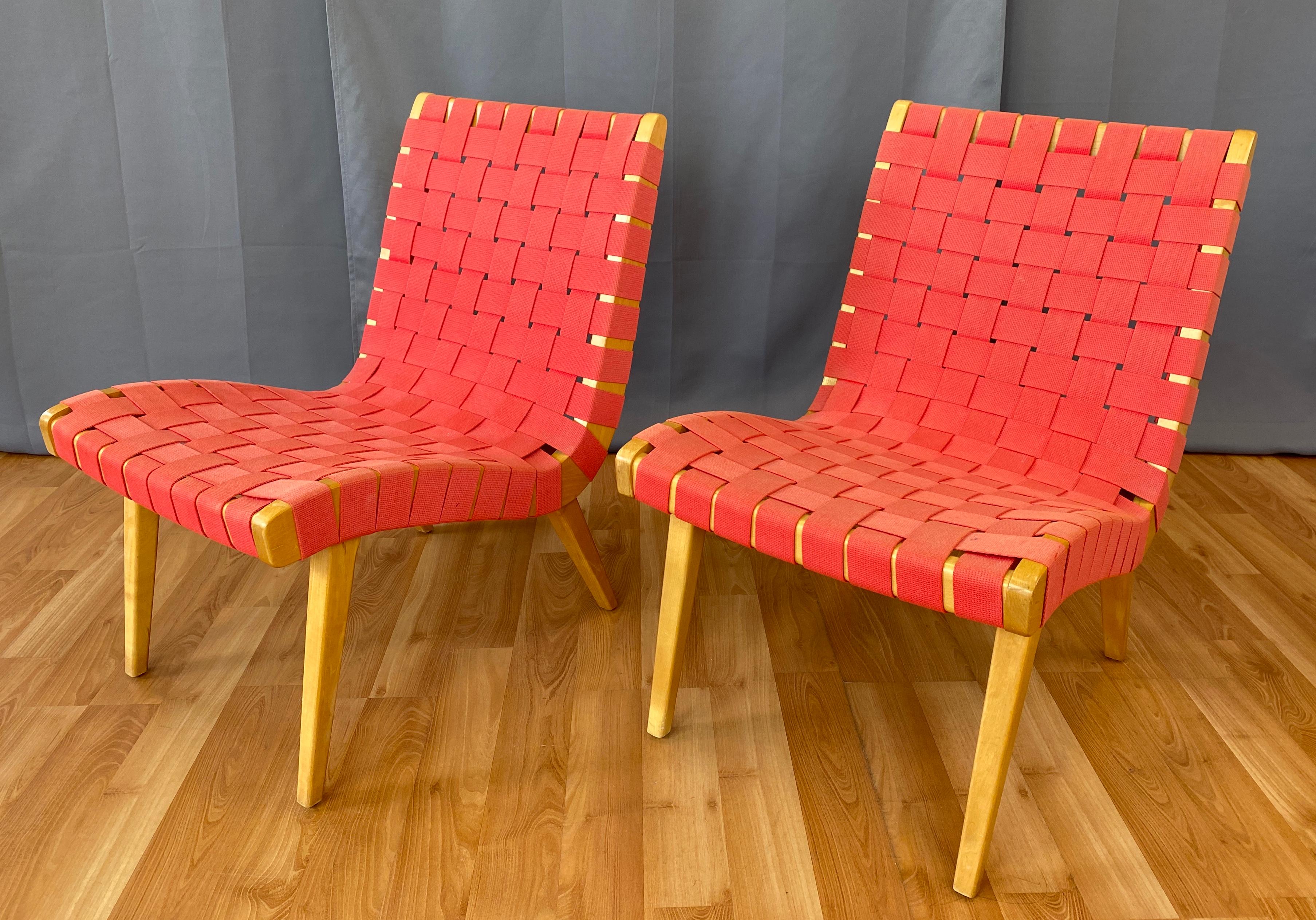 Offered here is a set of circa 1990s Jens Risom designed lounge chairs for Knoll.
First designed in 1943, and one of the first pieces commissioned by Knoll.
Clear Maple frame, with Red cotton webbing.