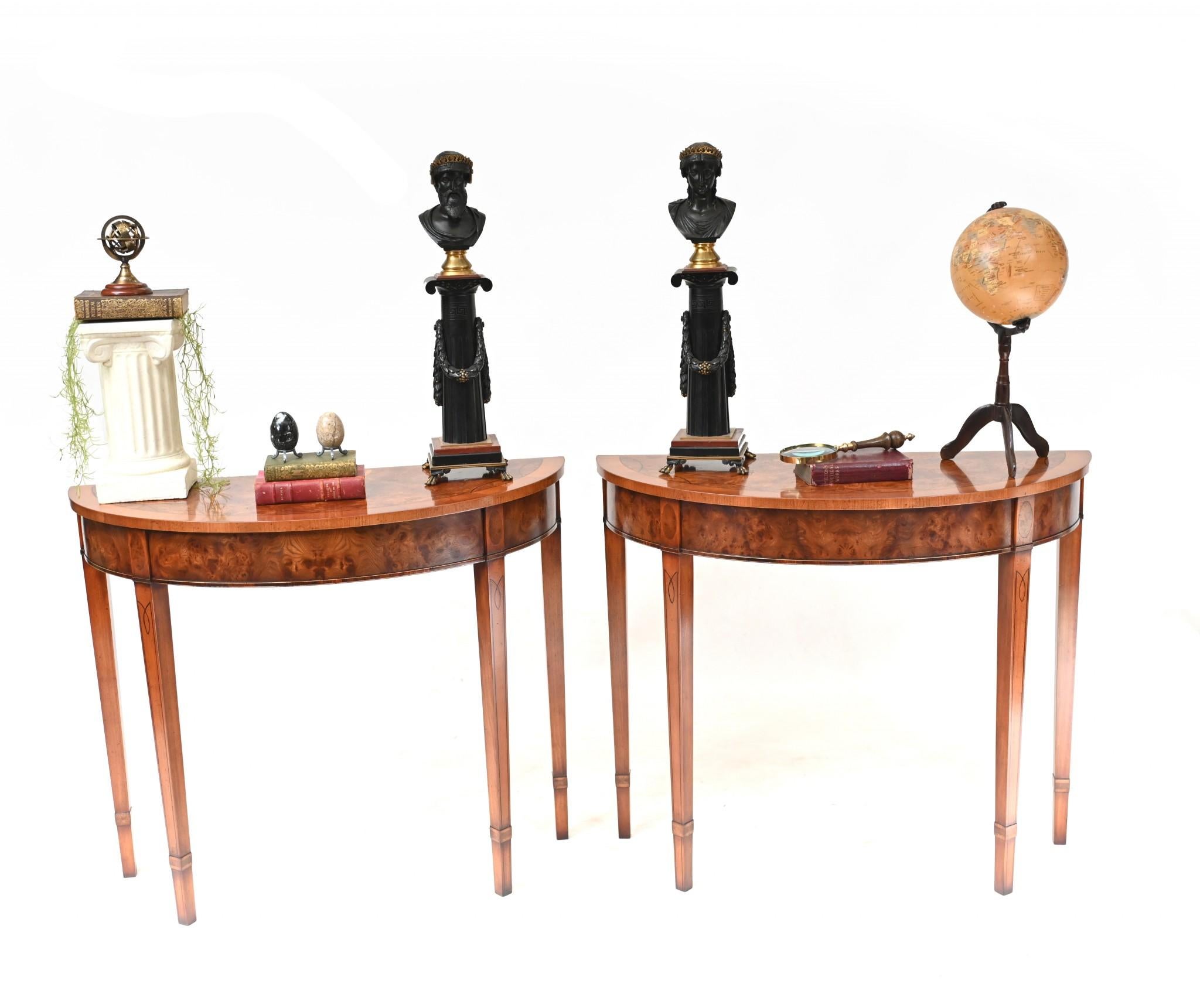 Pair opulent walnut console tables in the Regency manner
Features intricate inlay work including crossbanding and a shell motif to the centre in satinwood
Demi lune - half moon - form
Classically refined with clean design and tapered legs
Great