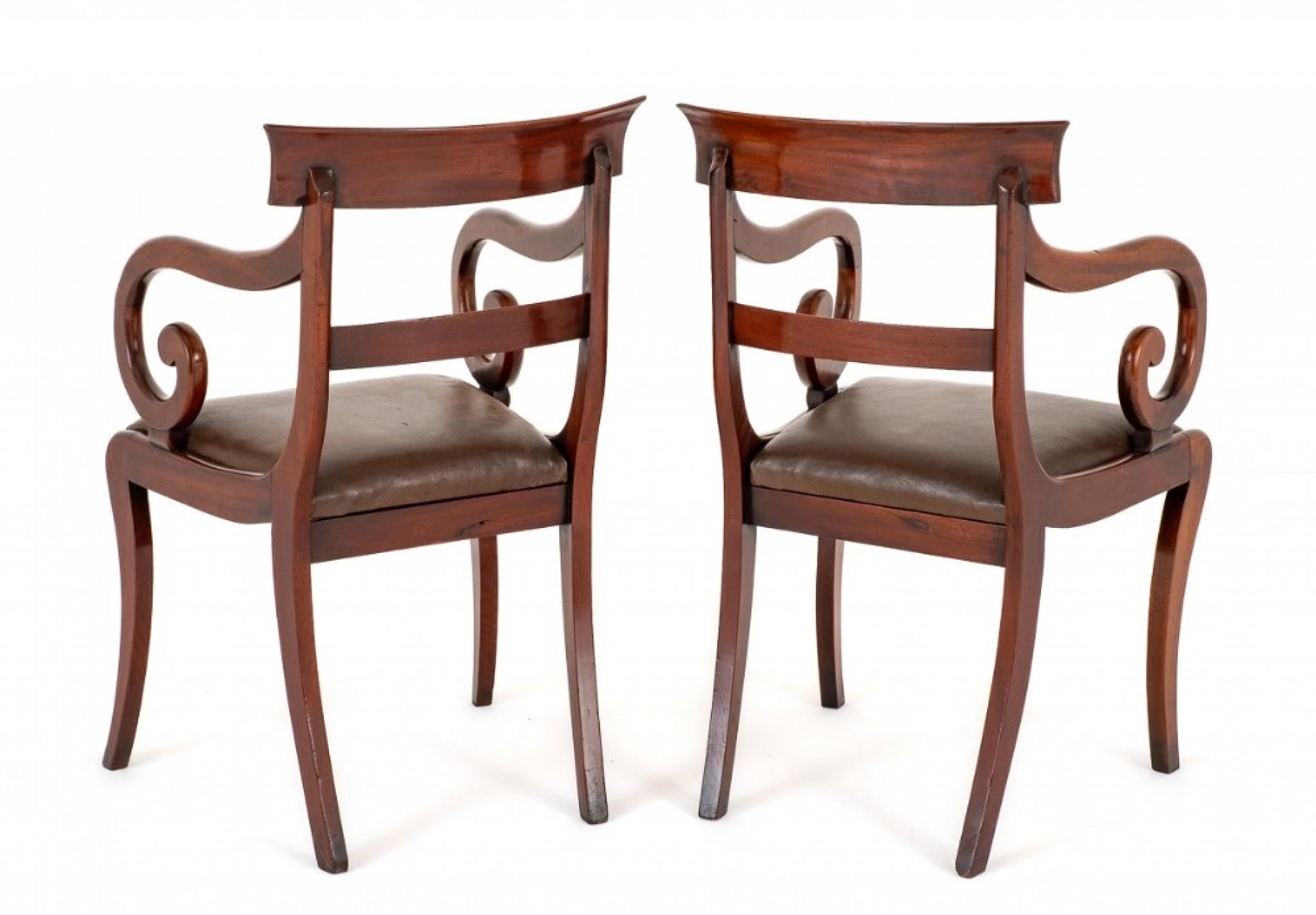 Pair of mahogany regency elbow chairs.
Regency period
these chairs are raised upon sabre front legs with shaped back legs.
Having lift out seats.
The chairs feature typical shaped regency arms.
The shaped top rail being of a plain form and a