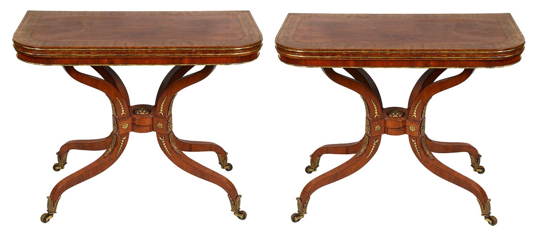 This exquisite pair of Regency period mahogany card tables showcases elegant craftsmanship and refined design. Each table features a beautifully grained mahogany top, enhanced by intricate brass inlaid crossbanding that adds a touch of