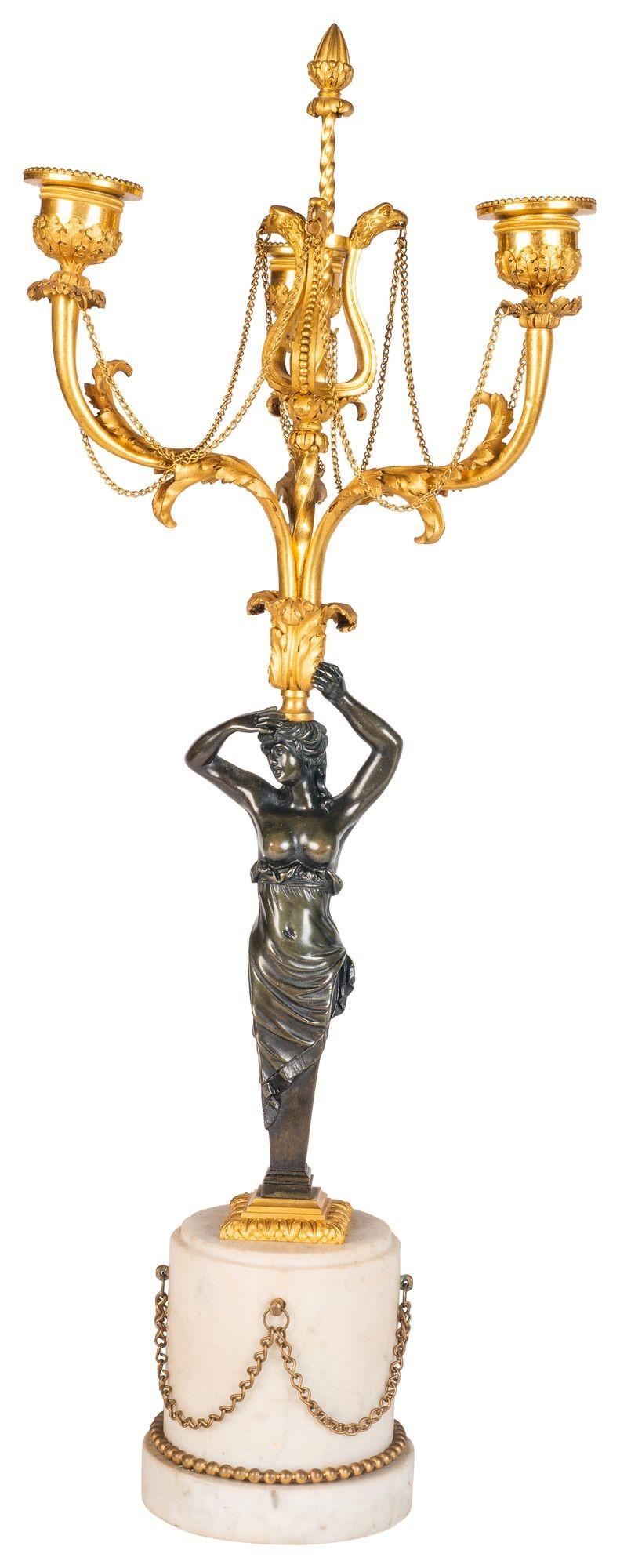 An elegant pair of Regency period bronze and gilded ormolu three branch candelabra, each having Swan neck and patinated bronze monopodia supports, mounted on Carrera marble plinths with chain swag decoration.

Batch 74