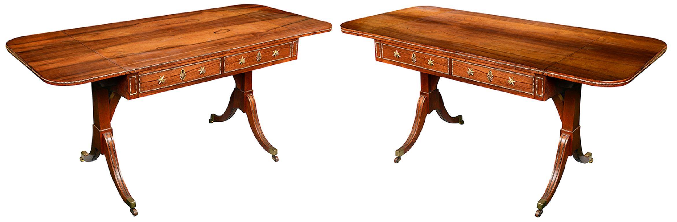 A rare Pair of Regency period Rosewood end support Sofa tables, each with wonderful figured veneers, gilded ormolu beaded mouldings, star back plate handles to the two Mahogany lined drawers and dummy drawers to the reverse. Raised on splay supports