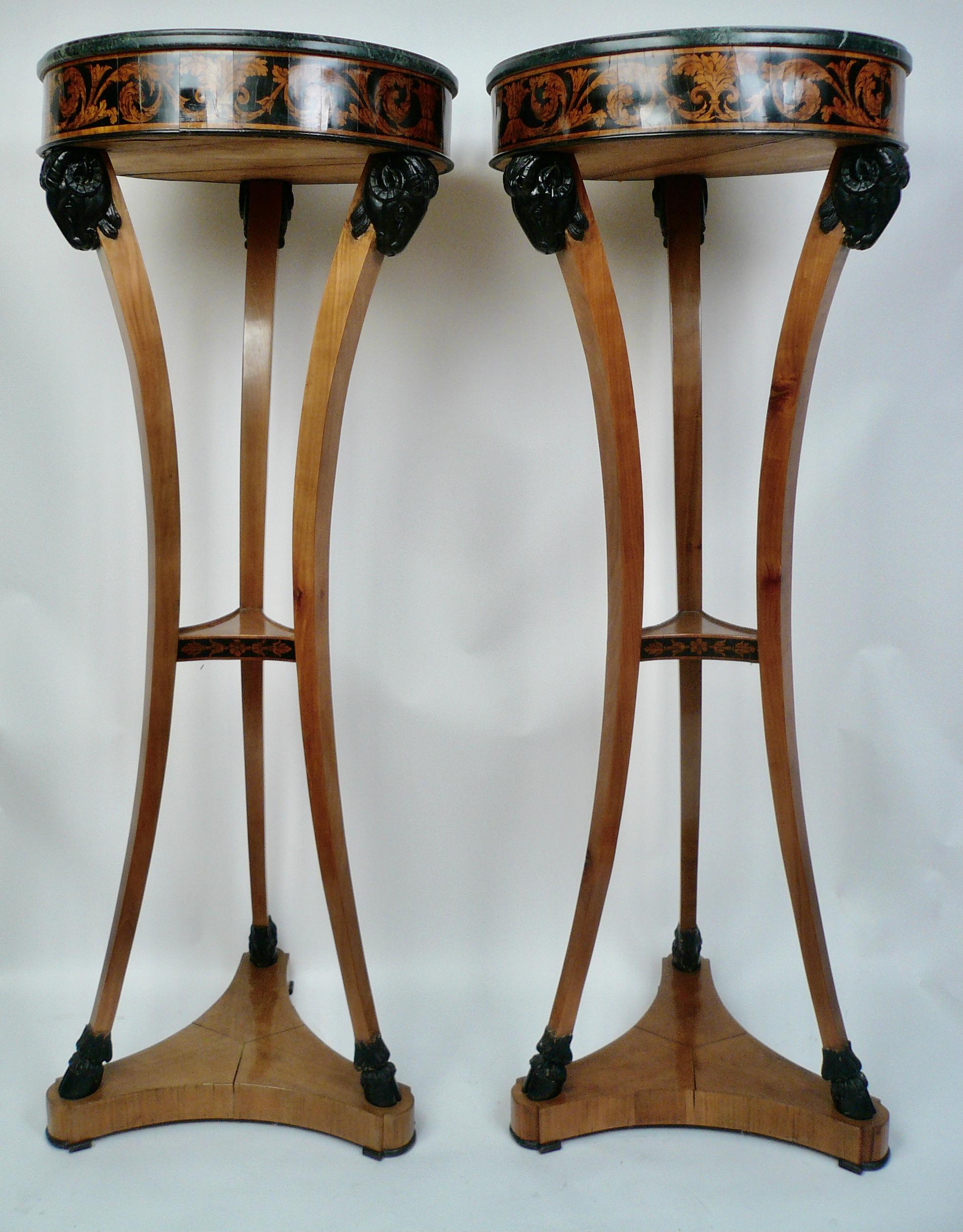 This handsome pair of satinwood gueridons feature carved and ebonized rams heads and hoofed feet, and 
green marble tops. They were purchased at Kentshire Galleries, New York in the 1980's, and retain their
Kentshire inventory label.
  