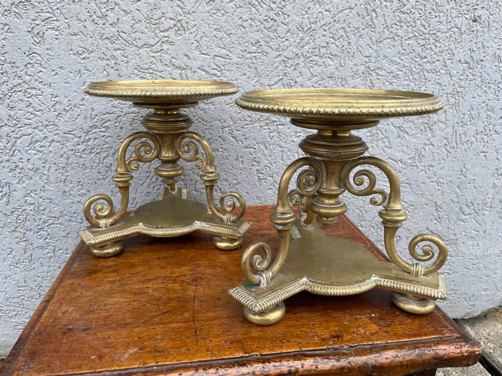 Handsome pair of English Regency brass compotes, or stands for serving or holding objects. Beautifully cast on tripod S-form bases supported by bun feet. The base and dish with gadrooned edges. 
These will make unique displays for fruit or candies,