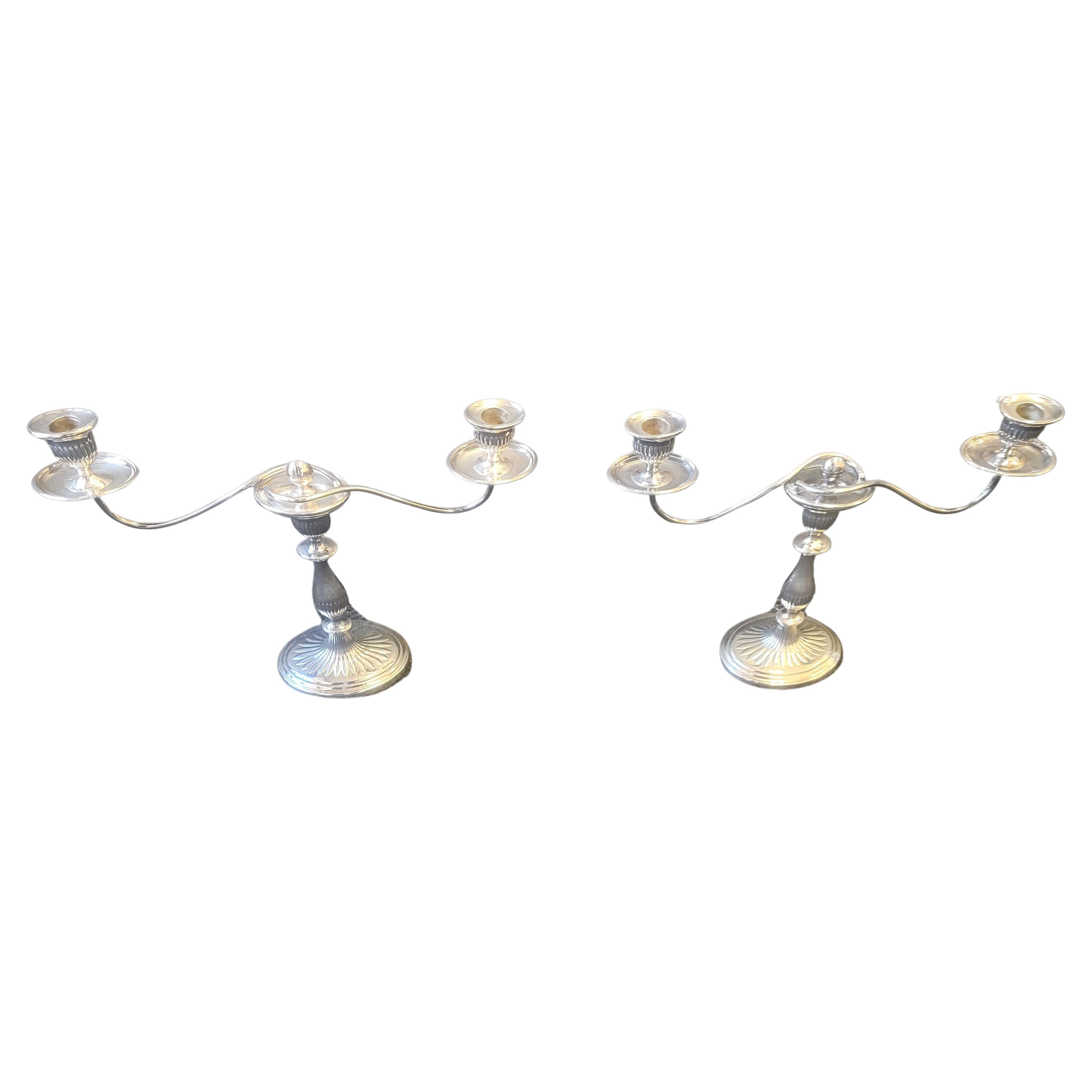 Pair Regency style English silverplate convertible one-to-three light candelabras in good vintage condition.
Measure 17.5 inches in width and stands 14 inches tall. Oval base is 6