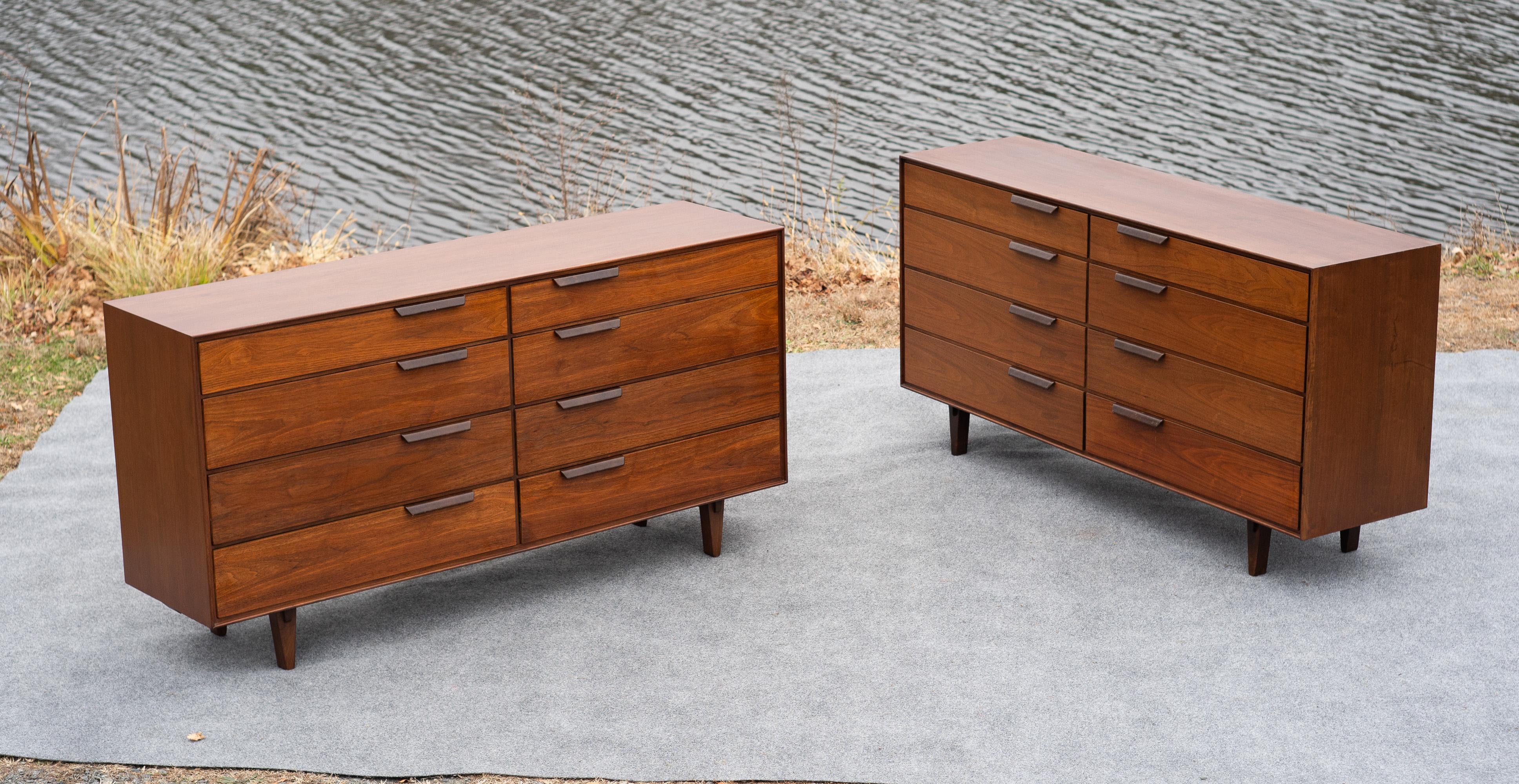 This pair of dressers was designed by decorated design icon Edward Wormly for equally revered manufacturer Dunbar Furniture. Known for hundreds of successful designs and exceptional quality, these dressers are no different. The walnut has been