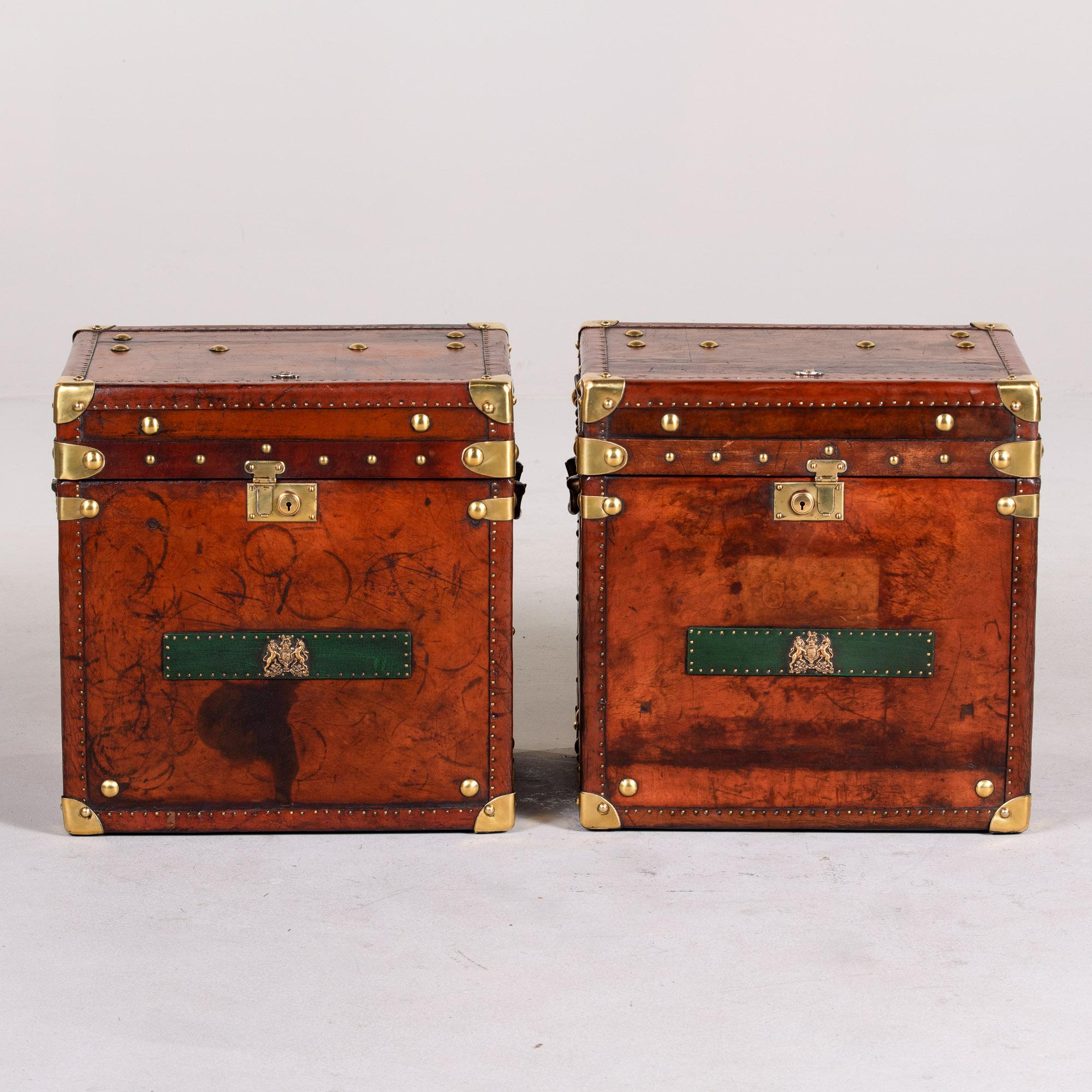 Found in England, this pair of circa 1930s pair of leather and brass trunks have been professionally restored. Leather has been reconditioned and patched where needed. Interiors have been recovered in a red velour and the brass hardware and