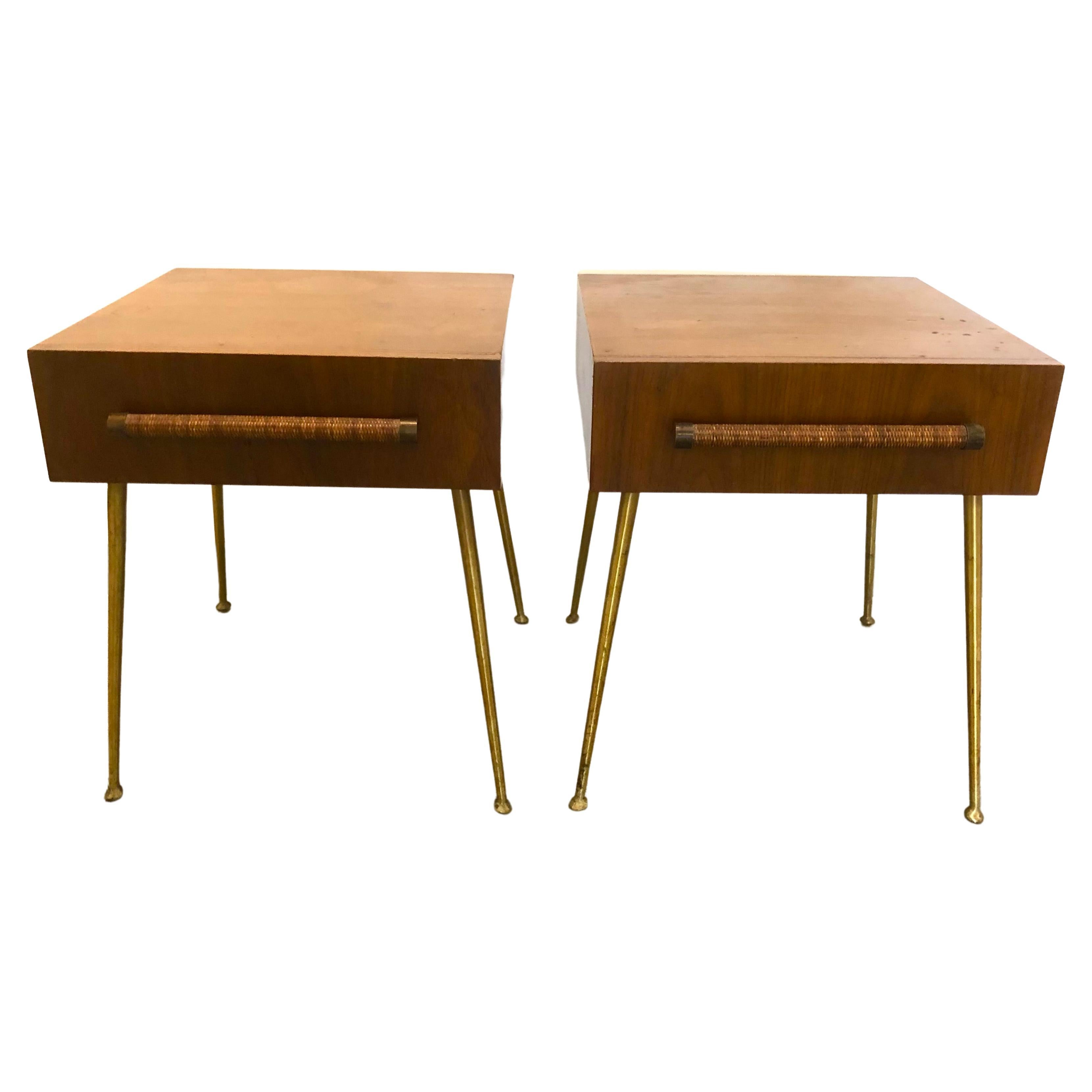 Iconic pair of T.H. Robsjohn Gibbings for Widdicomb end tables or nightstands. Single drawer with rattan-wrapped pulls, raised on long tapering brass legs. Widdicomb labels to inner drawer.