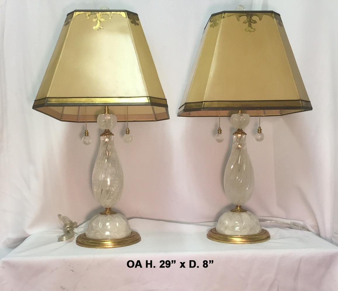 Fabulous pair of hand carved and hand polished rock crystal spiral lamps with ormolu resting on round gilt bronze bases coming with rock crystal chain pulls and finials.
With hand painted and gold leafed square shades.
Late 20th century
Shade