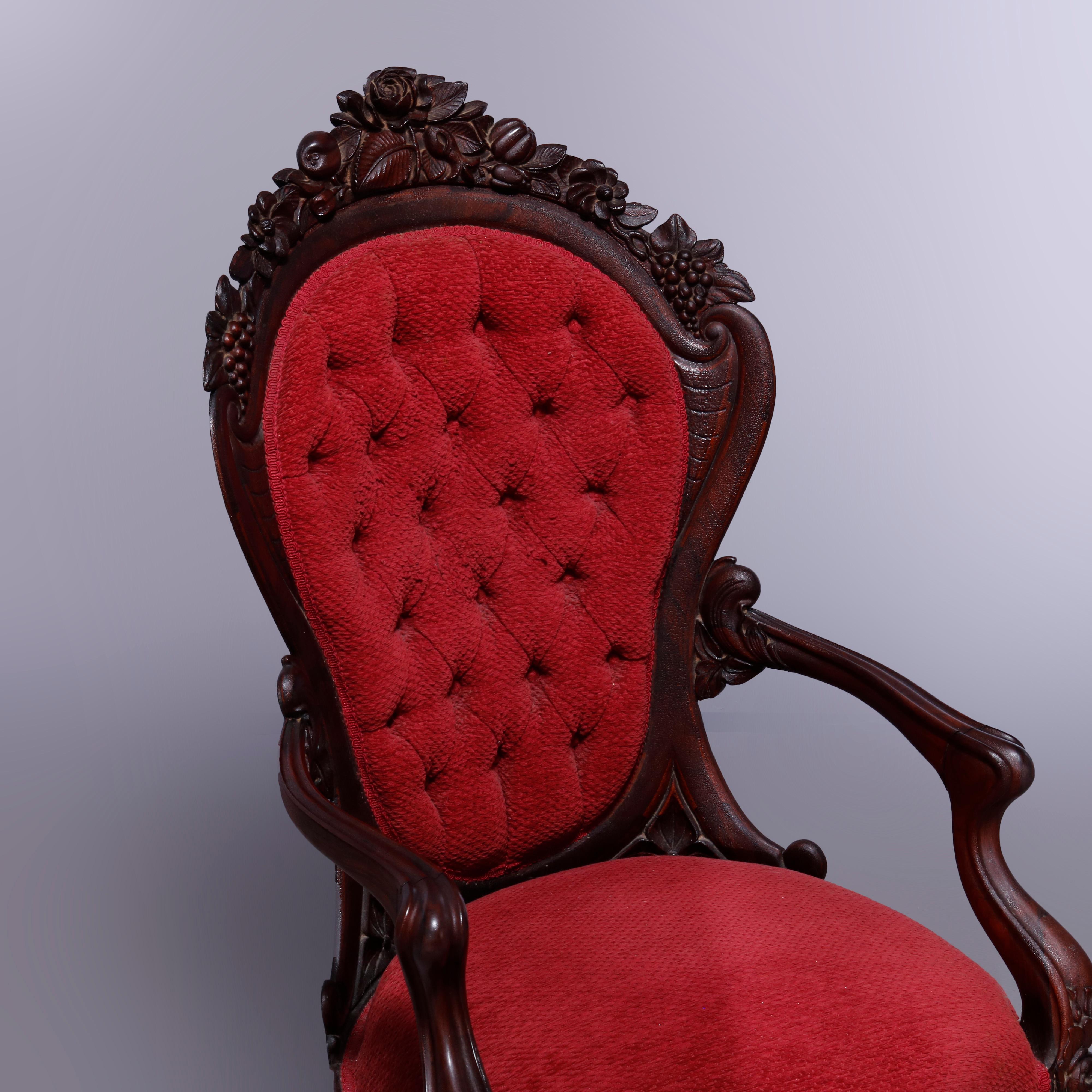 An antique Rococo Revival Belter Rosalie armchair offers laminated rosewood construction with carved still life crest having fruit, flowers and nuts over button back with flanking scroll form frame, upholstered seat and raised on cabriole legs,