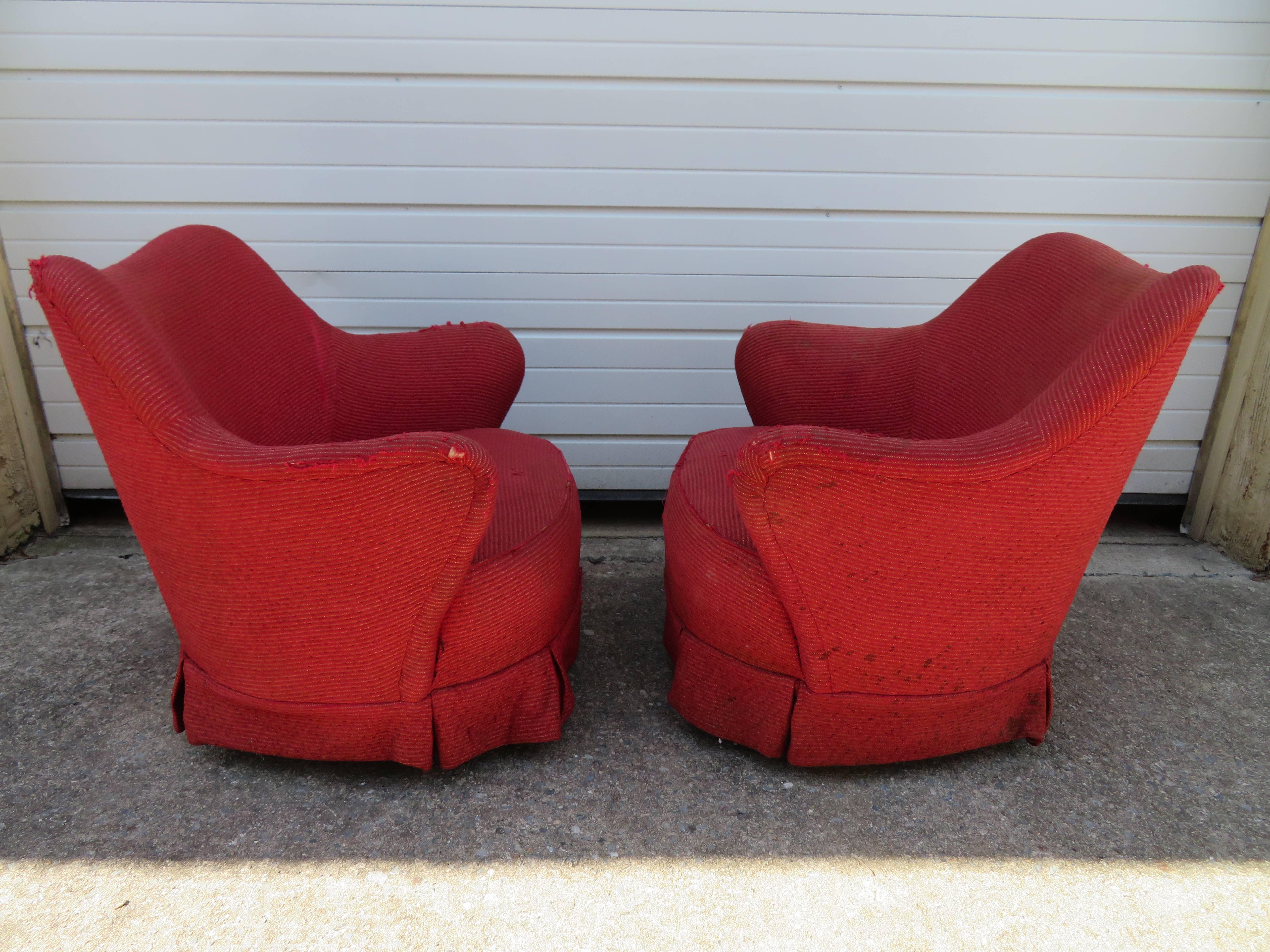 A pair of Mid-Century Modern Classic barrel back chairs designed in the 1940s, with wing like arms that attach to the barrel back. These chair will most certainly need to be re-upholstered but oh those bones are fabulous!
   